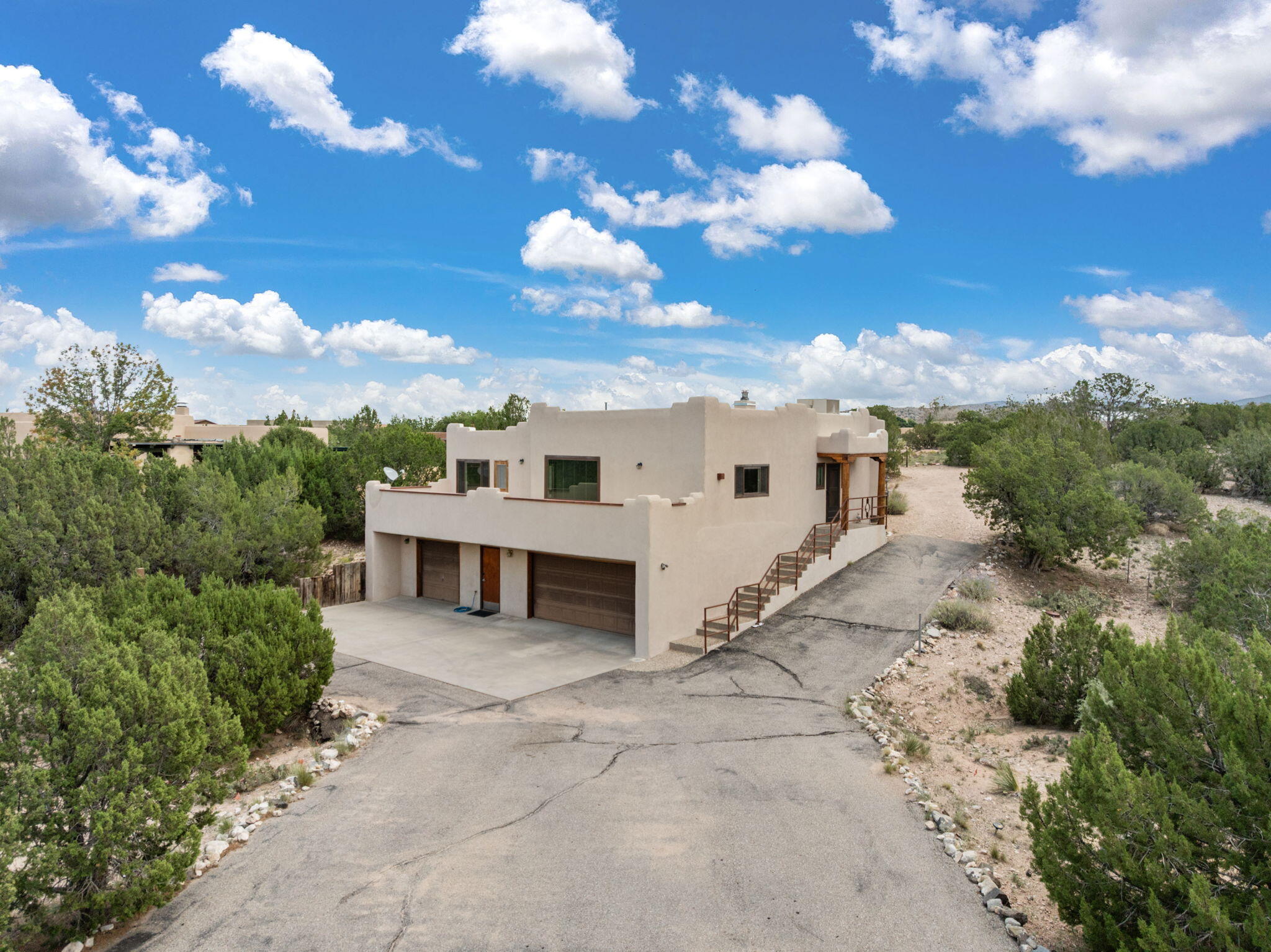 This custom one owner home has 3-bedroom, 2.5-bath set in beautiful Placitas it has everything you need for comfortable living-with plenty of extras. Inside, you'll find warm wood beams, a cozy wood-burning stove to keep everyone comfortable year-round. Some features include TPO roof, Master cooler, newer windows and the open layout makes the home feel spacious and inviting. One of the standout features is the heated 3-car garage, complete with an attached workshop / storage space with a half bath.  Whether you're relaxing at home or working on something in the garage, this home gives you the space and flexibility to do it all.