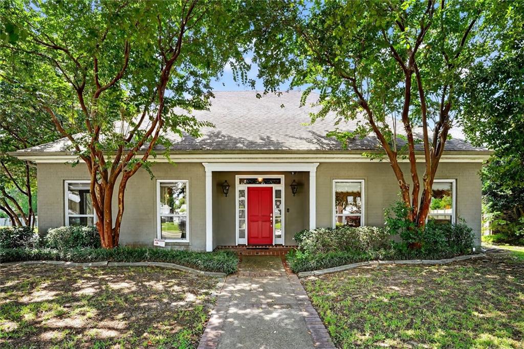 This 4-bed/4-bath Metairie Estates home is the defining example of elegance, comfort and privacy. Situated on a corner lot lush with foliage on a quiet dead-end street and clocking in at a sprawling 3800+ total square feet, this stunner offers amenities and pure style throughout: main living area with wood flooring, a wet bar, built-in bookshelves, wood-burning fireplace, tray ceiling with discrete cove lighting and an attached dedicated office space; dining room for more formal affairs; Chef’s dream of a kitchen with all-wood cabinetry, island with bar seating, and a cozy attached breakfast nook. 3 bedrooms boast ensuite bathrooms and all 4 bedrooms have walk-in closets! The 2 bedrooms on the lower level include the primary bedroom ensuite with dual vanities, private shower and garden tub; 2nd lower-level bedroom has access to the hall bathroom via the walk-in closet, and this room could also be used as an office/additional living area/etc. Remaining 2 ensuite bedrooms are located on the upper level and both boast TWO walk-in closets each!! The unique attached 2-car garage features roll-up doors on both the street and backyard sides. Fenced backyard includes a covered wooden porch with a ramp for accessibility. Roof and both the upstairs and downstairs A/C units are all less than 5 years old! This highly-coveted opportunity simply awaits your call—SCHEDULE YOUR VIEWING APPOINTMENT TODAY!