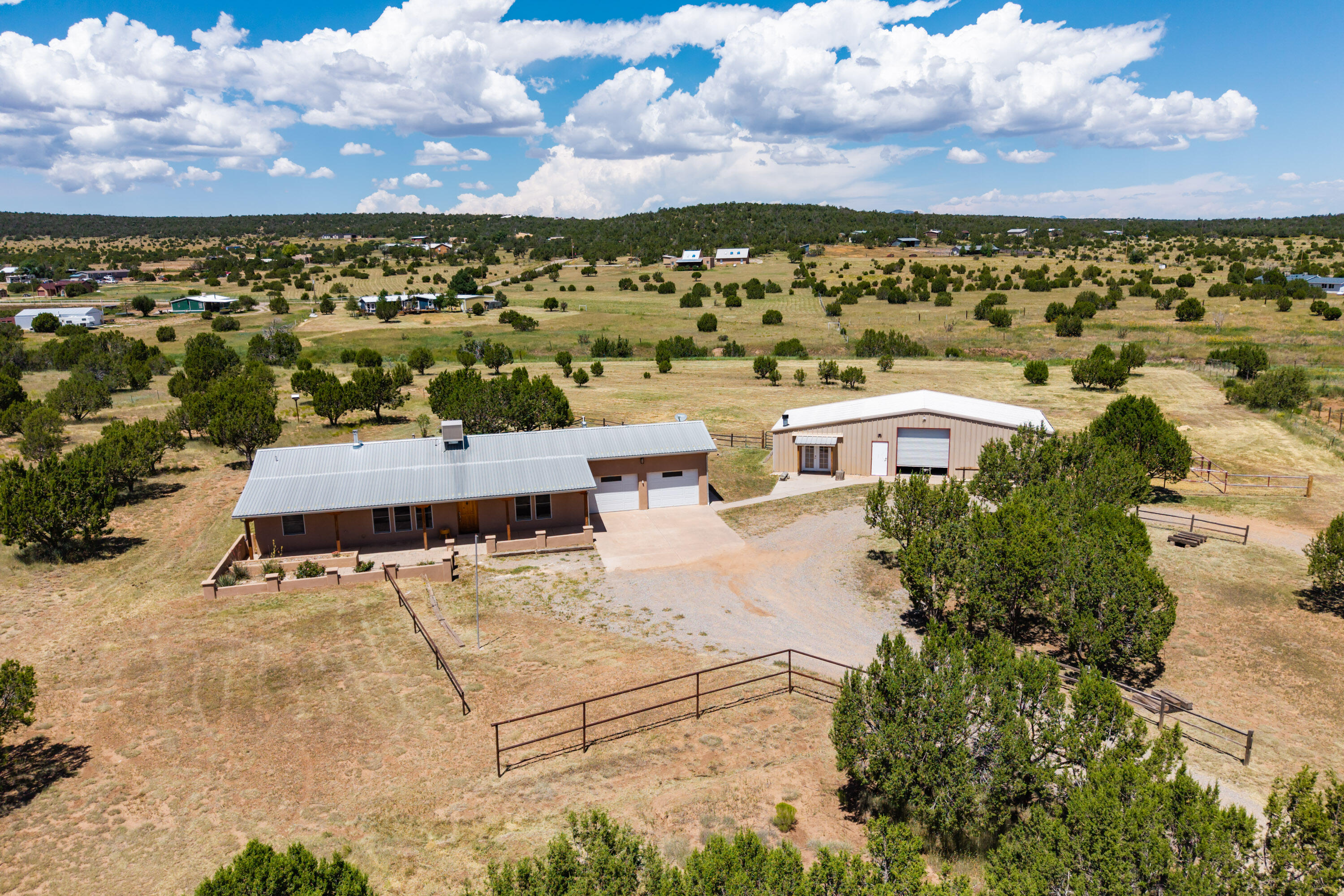 Experience exceptional country living in this impressive home, perfectly situated on a fully fenced 5-acre property designed with horse facilities and a spacious barn/shop (25x55). Inside, enjoy the comfort of single-level radiant heat and durable concrete floors throughout. The gourmet kitchen boasts granite countertops, stainless steel appliances, a 6-burner Wolf cooktop, double ovens, and beautiful Pella wood windows that flood the space with natural light.Freshly painted and fitted with a Navien tankless water heater/boiler, backup generator, and professional engineered drainage system, this home is built for convenience and peace of mind. The bonus room off the laundry provides versatile space for your needs. A 3-car garage and circular drive offer ample parking and easy trailer