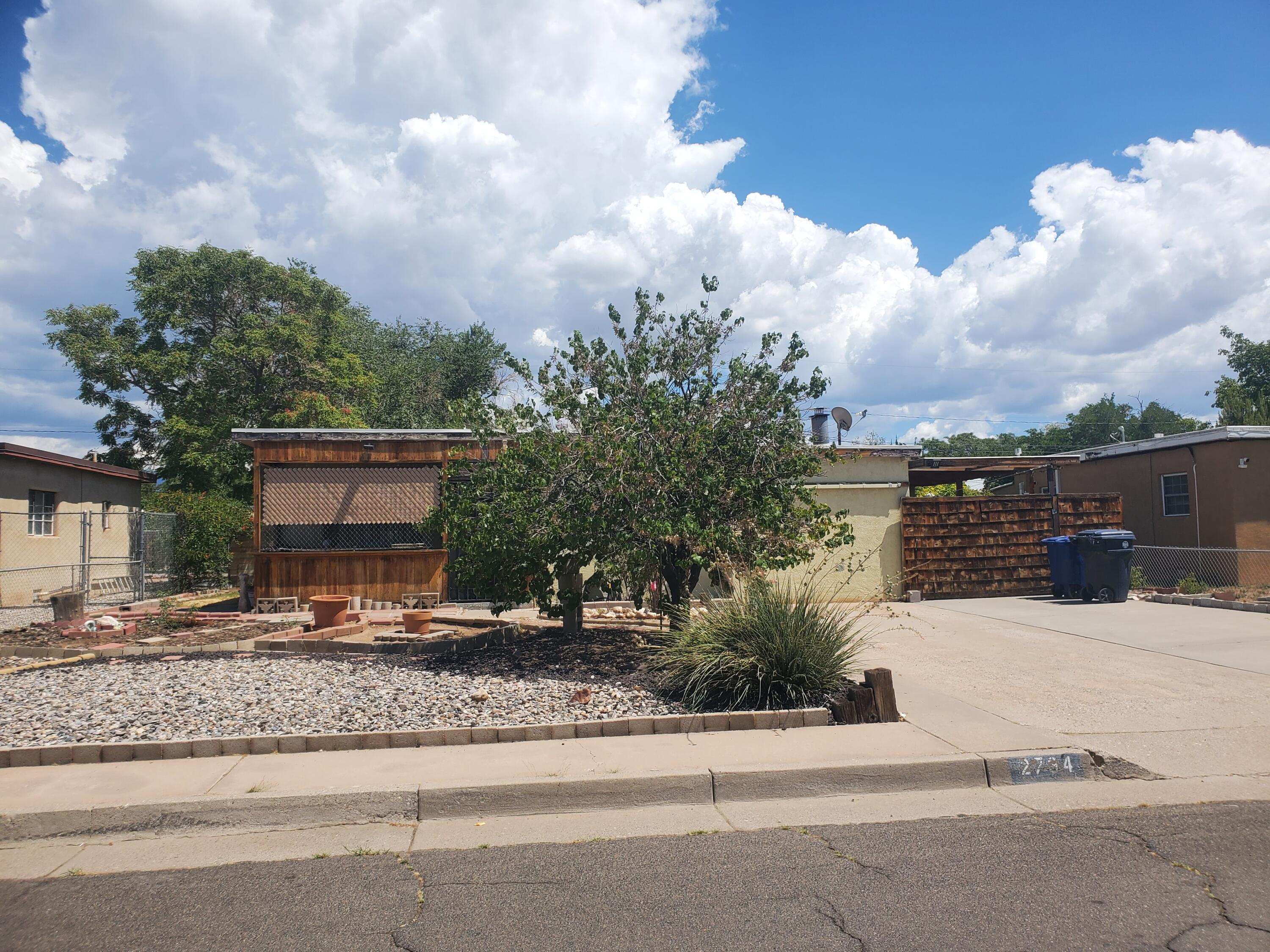 Investor Special! Tons of potential in this 2-bedroom home with an office that could easily be converted into a 3rd bedroom. Featuring 1 bathroom, 2 living areas, and a spacious backyard that's fully fenced with convenient alley access, a covered patio, workshop, and multiple storage sheds. A great opportunity for sweat equity--bring your vision and make it shine. Ready for its new owner!