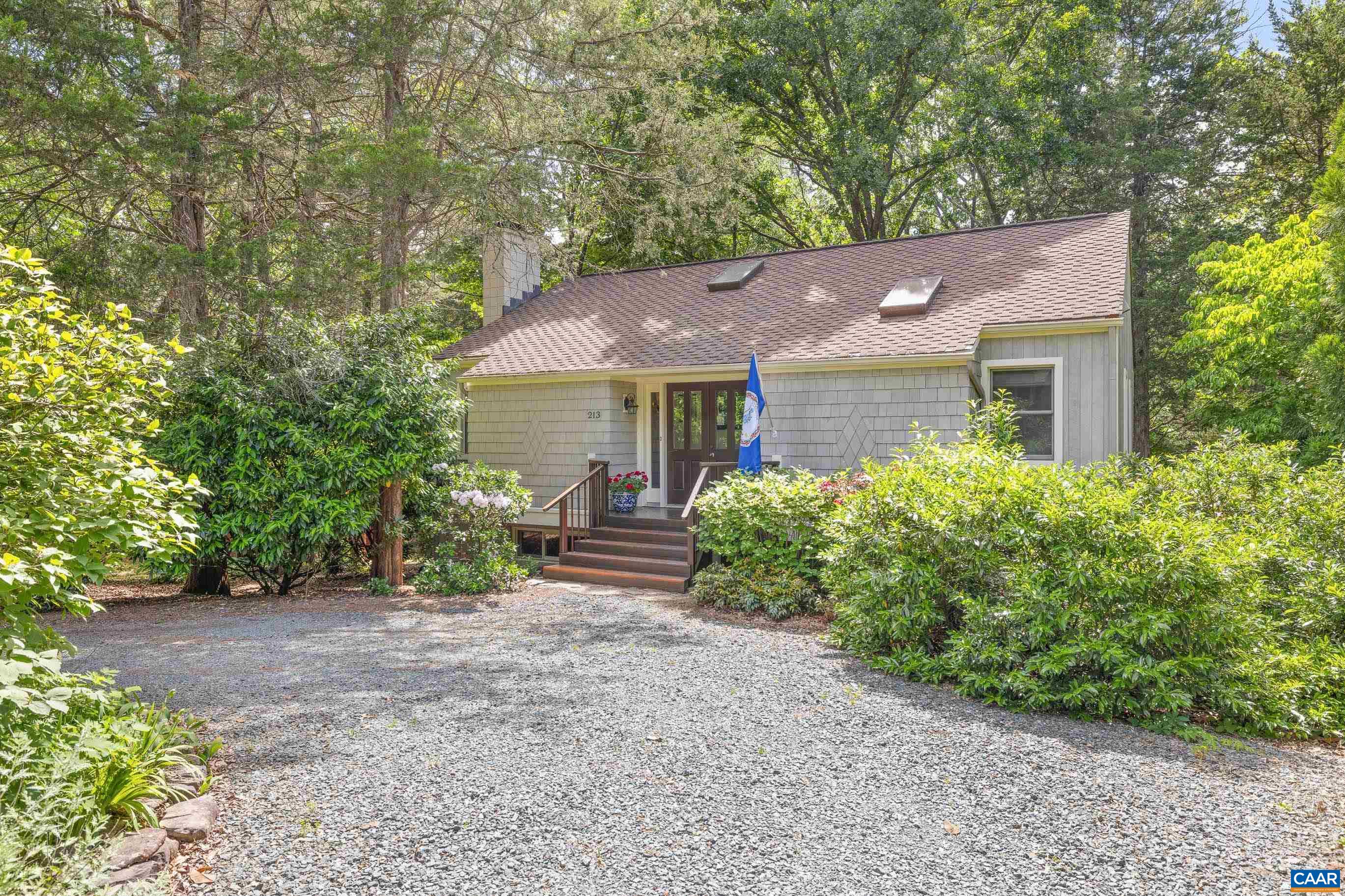 Located in the serene, conservation-minded community of Peacock Hill, this residence combines rural tranquility with the convenience of being just minutes from Charlottesville and UVA in Western Albemarle County. Set within a coveted neighborhood of single-family homes on 350 acres, including 98 acres of protected woodlands, the home is tucked away in a private setting within the sought-after Murray school district.  Inside, the floor plan highlights main-level living with wood floors, built-in bookcases, and an inviting kitchen with updated maple cabinets, solid-surface countertops, and ample storage—designed to keep you connected while cooking or entertaining. Two fireplaces serve as central features in the living areas.  Step outside to a private outdoor retreat designed for relaxation and entertaining. A sunken spa/hot tub sits beneath a gazebo, creating a sheltered space to enjoy in every season. The setting is complemented by mature landscaping and direct access to community-owned land through the woods. Residents of Peacock Hill also enjoy amenities including a 5-acre pond for fishing and canoeing, tennis courts, playgrounds, sledding slopes, & miles of walking trails.