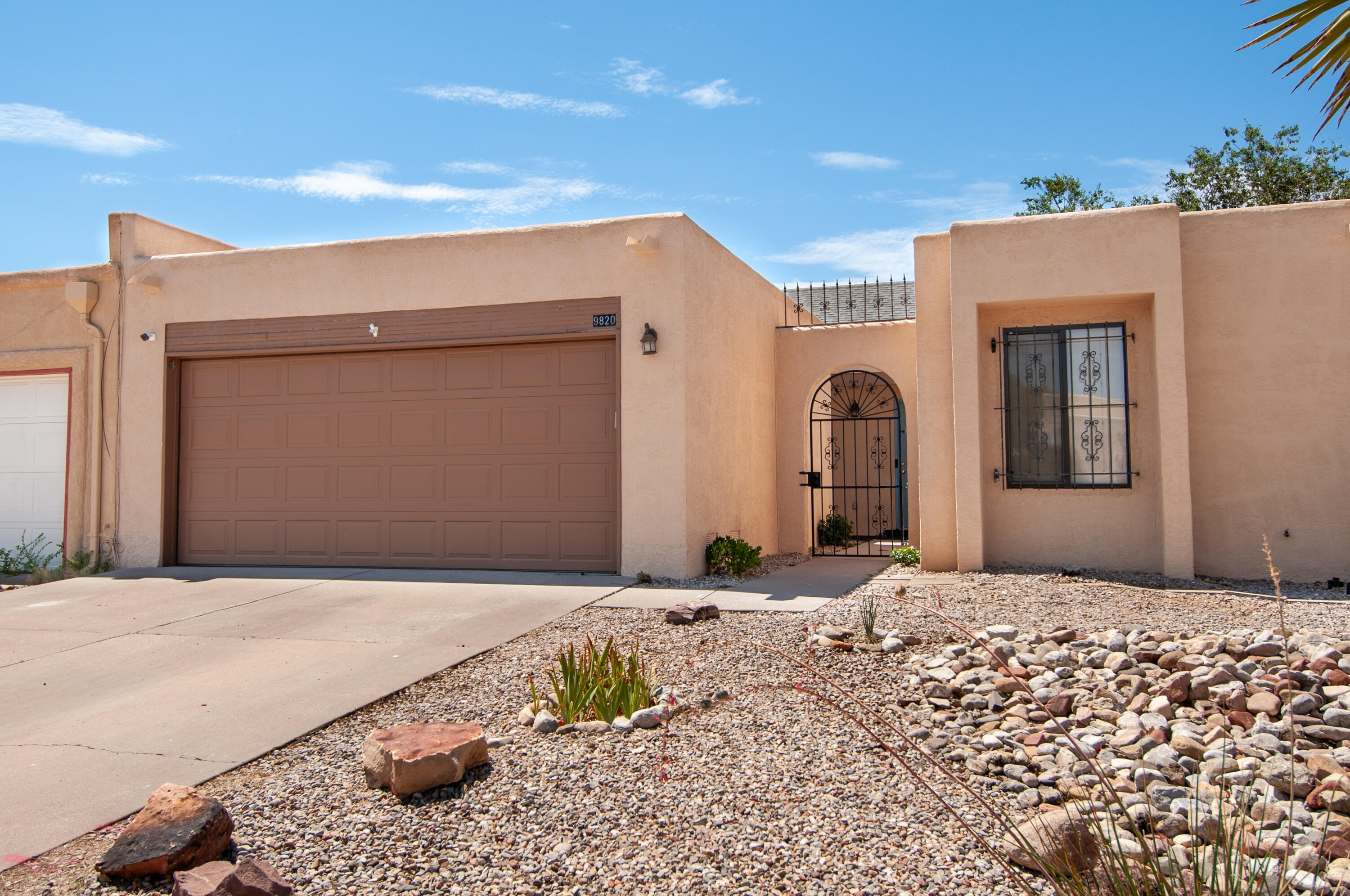 Charming townhome in the far NE Heights near Eubank and Layton.  Beautiful features throughout.  Enter through gated courtyard to the welcoming entry.   Bright, open family room with cathedral ceilings and wood beams.  Kitchen has been updated with cabinets, quartz counters, lovely tile backsplash and stainless appliances.  Contemporary and timeless.  Primary is spacious and opens to backyard courtyard.  Full bath attached and walk-in closet.  Down the hall are 2 more bedrooms and another refurbished bath.  Enjoy the backyard patio and perfect-sized easy-care backyard.  TPO roof, and Mastercool.  Home is spacious and feels detached.   Close to grocery stores, several restaurants, just a great part of town.  Come see today!