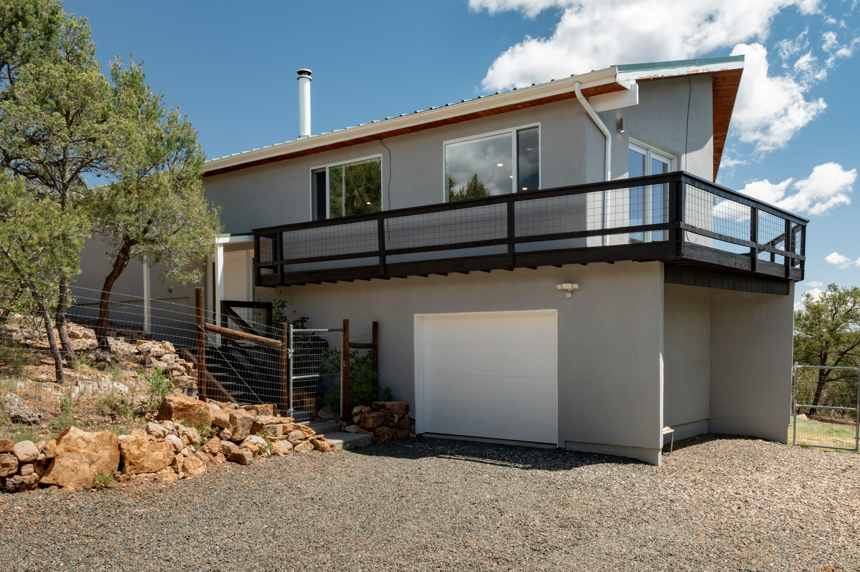 Located in the heart of Cedar Crest, this fully renovated home offers direct access to open space trails and incredible mountain views. The open floor plan features luxury vinyl and saltillo tile floors, tongue-and-groove ceilings, and a stunning kitchen with granite counters, stainless appliances, soft-close cabinetry, and stylish tile accents. Large picture windows and sliding doors frame breathtaking views while filling the home with natural light. Bedrooms and baths have been beautifully updated with new vanities, lighting, and custom tile surrounds. A versatile bonus room works perfectly as an office, gym, or 4th bedroom. Additional highlights include a metal roof, newer stucco, fenced and gated yard, all just minutes to shopping, dining, and only 15 minutes to Albuquerque.