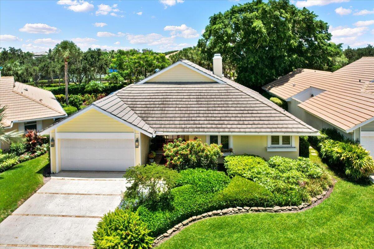 Discover your dream home in the sought-after Crosswind community of prestigious Jonathan's Landing! This 2-bedroom, 2.5-bath residence offers a layout ideal for comfortable living and elegant entertaining. Enjoy a bright living room with charming wood burning fireplace, inviting dining area and French Doors to a tranquil screened patio, updated kitchen with newer cabinets, countertops, and appliances. The spacious primary suite features, 2 walk-in closets, ensuite bath with dual sinks and walk in shower and French Doors to the screened patio. The guest suite offers a full bath and dressing area ideal for family or guests. The versatile den, built-in dry bar can easily convert back to a closet  for a third bedroom! Relax or entertain on the screened porch with garden view and water feature Recent updates and highlights include a NEW roof, trim, and skylight (2024), new hot water heater (2022), hurricane-rated garage door (2015), central vacuum. Social, tennis, and golf memberships are optional. Minutes from beaches, shopping, and dining. Don't miss this exceptional opportunity!