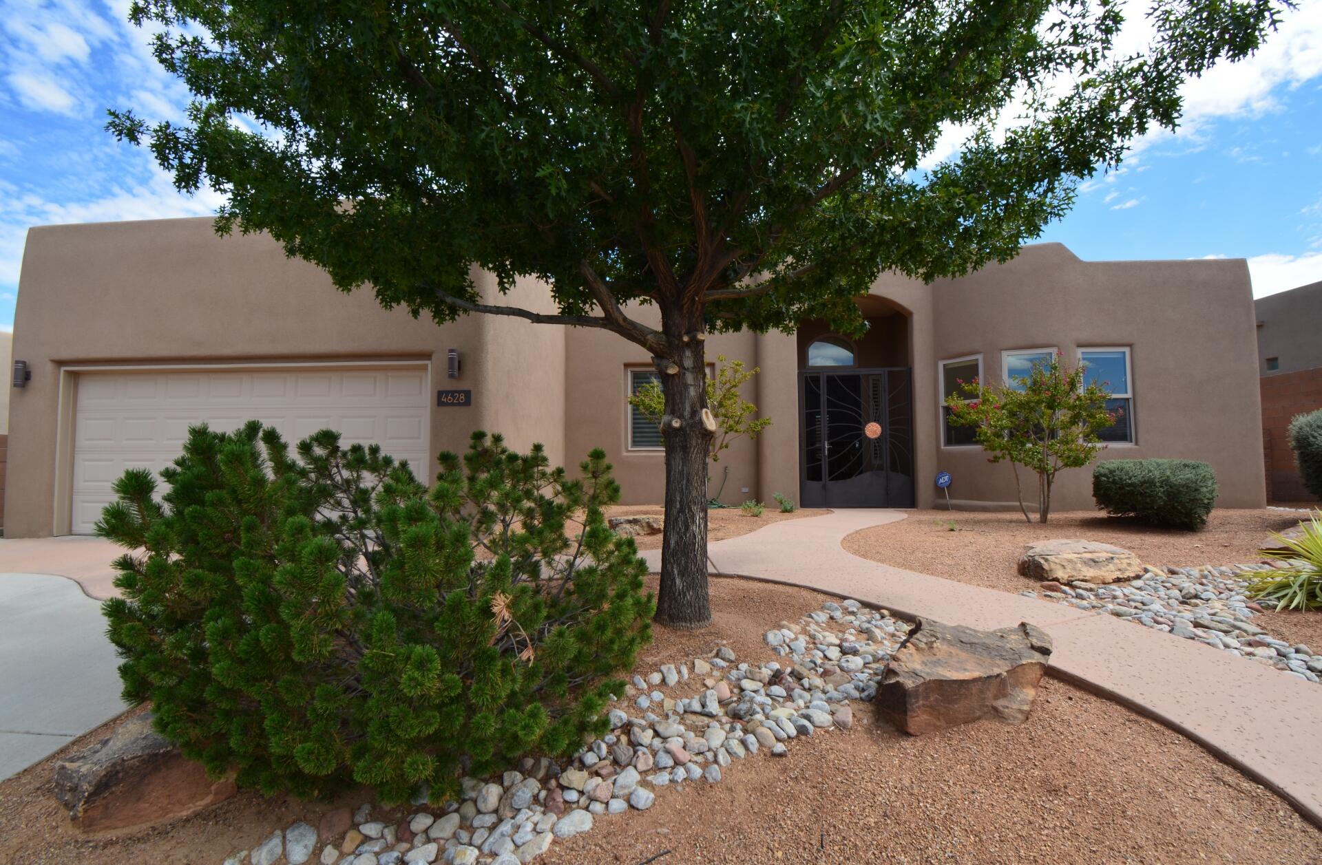 Welcome to this beautifully maintained former model home, showcasing numerous high-end upgrades. Featuring spacious living areas and soaring high ceilings, this home is filled with natural light, enhanced by skylights throughout. The gourmet kitchen is a chef's dream with Corian countertops, a large island, and quality cabinetry by Davis Kitchen perfect for entertaining or family gatherings. The oversized primary suite offers a true retreat with a luxurious jetted tub and a generous walk-in closet. Enjoy year-round comfort and style with custom blinds, a recently updated stucco exterior (2 years ago), and new gutters. Step outside to fully landscaped front and back yards, ideal for relaxing or entertaining. Additional highlights include a 3-car tandem garage, a custom iron front gate.