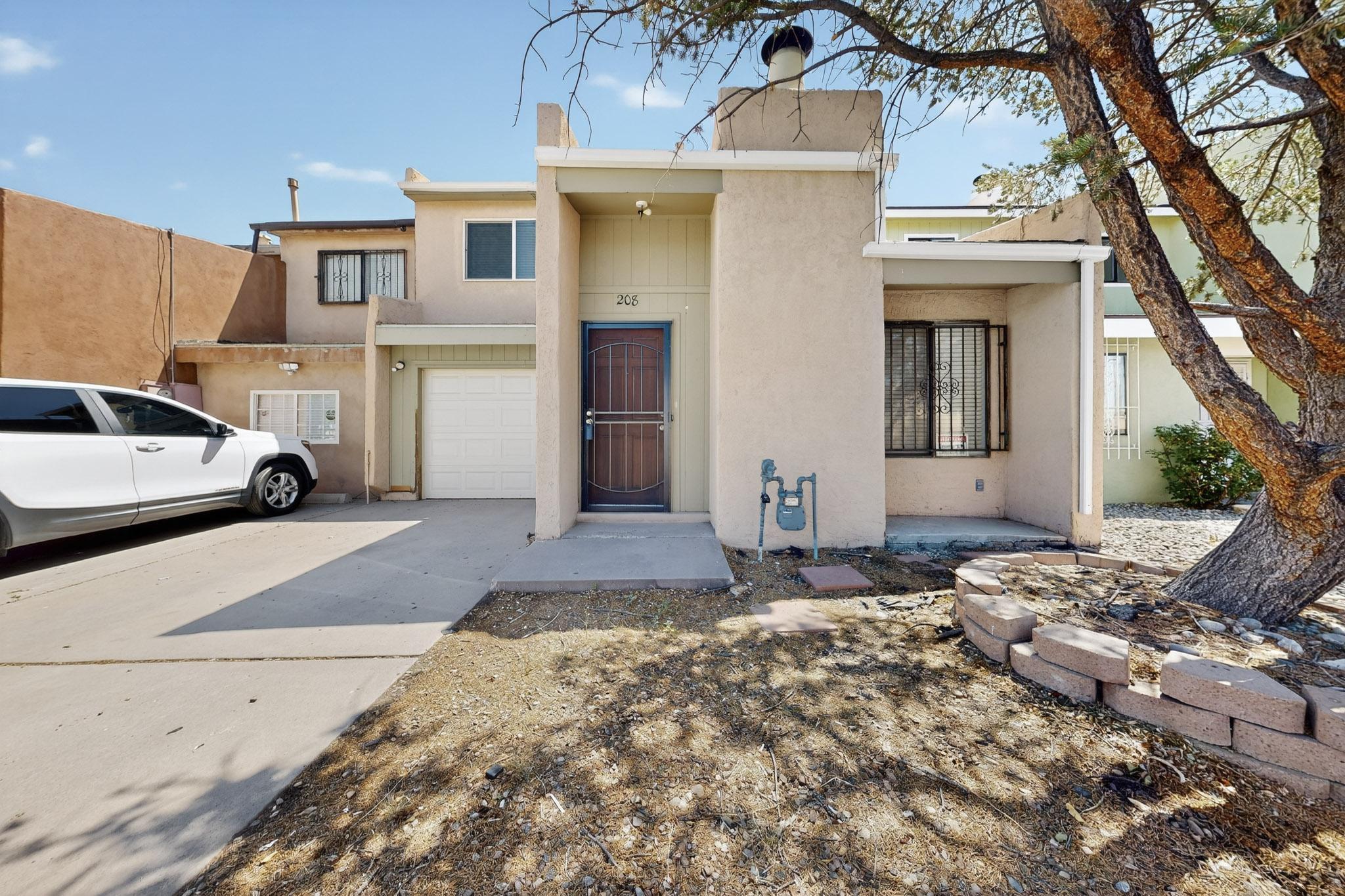 WELCOME TO A TOWNHOME THAT FEELS JUST RIGHT. Step inside this two-story Albuquerque casa and picture yourself curling up by the cozy fireplace in the living room. Enjoy easy maintenance with your modern tile and wood-look floors. The kitchen flows easily into the living space, making every gathering feel connected. Upstairs, two bedrooms and a full bath with a garden tub offer comfort and relaxation, while the downstairs half bath adds convenience. A large fenced backyard with shade is perfect for summer afternoons, pets, or a quiet garden, and the one-car garage adds practical ease. Move-in ready, this home is waiting for you--come see it today before it's gone!