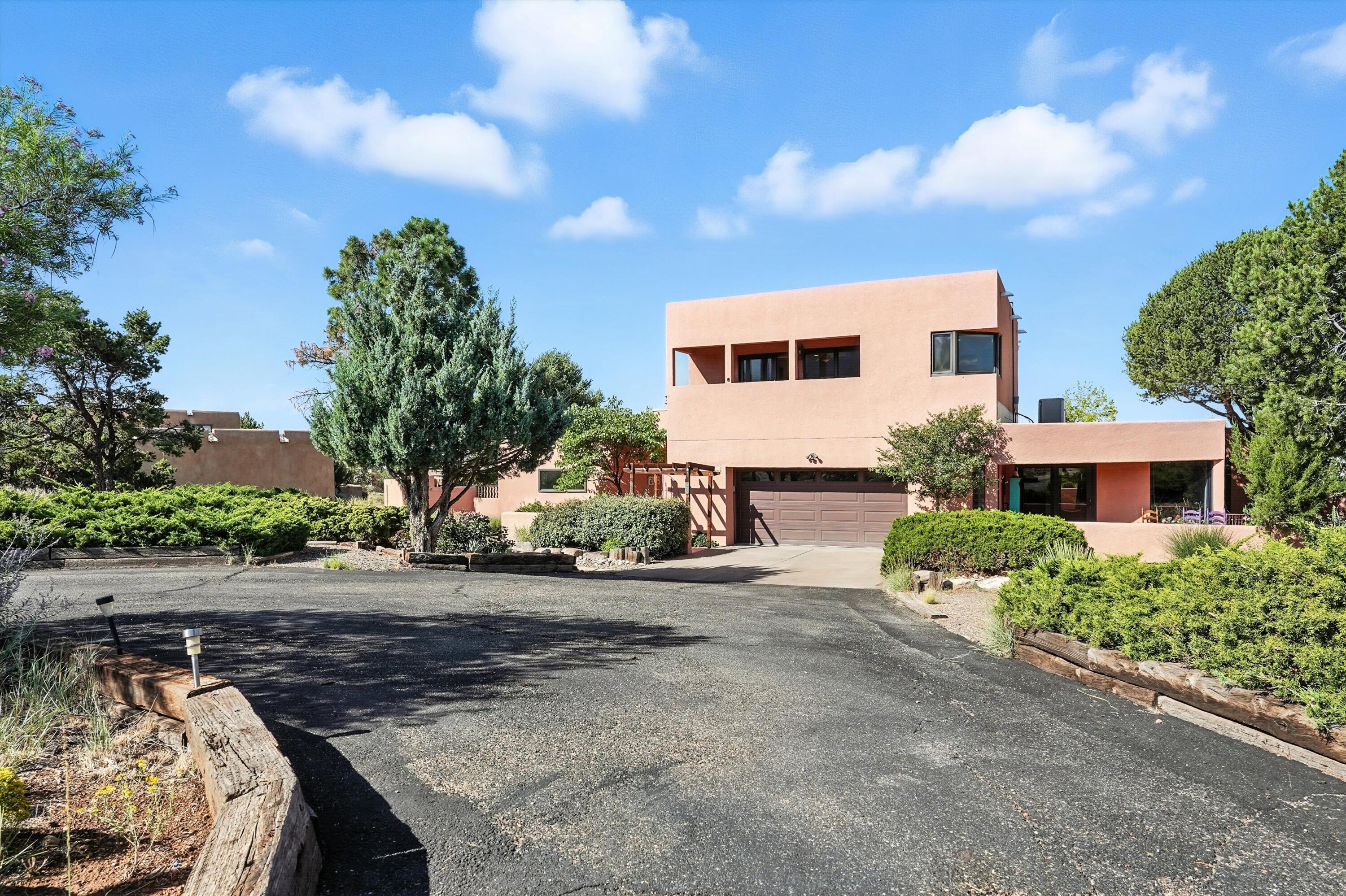 Discover this beautifully updated custom residence nestled on a spacious .7-acre lot in the coveted Sandia Heights community. Designed for comfort and versatility, this home features two luxurious primary suites, a formal living room with a cozy fireplace, and multiple patios and balconies perfect for relaxing or entertaining under New Mexico's breathtaking skies.&#127795; Enjoy natural landscaping, garden space, lawns and mature fruit trees, a huge hobby room ideal for creative pursuits, and abundant storage throughout. With refrigerated air for year-round comfort and panoramic views of the city and Sandia Mountains, this home offers the perfect blend of tranquility and convenience.Whether you're hosting guests or enjoying quiet moments, this property is a true retreat.