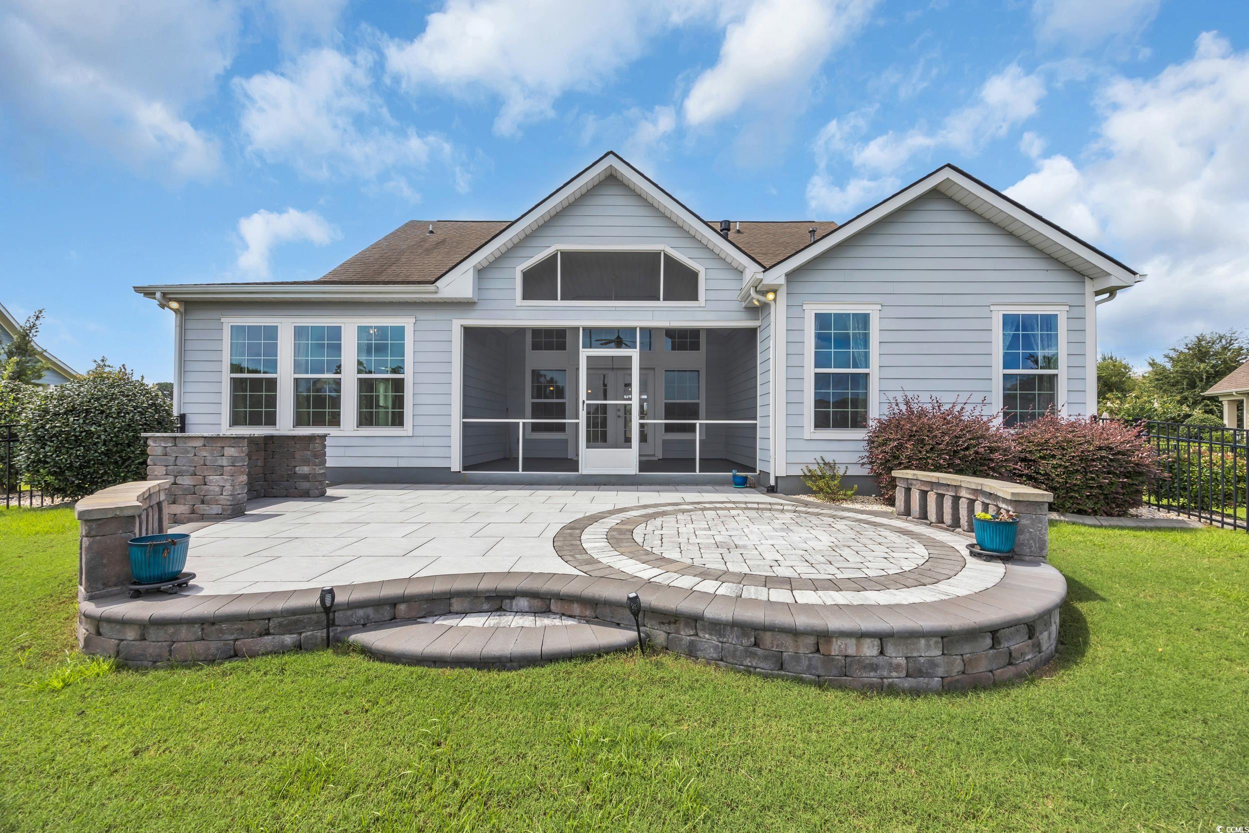 Back of property featuring a patio and a sunroom