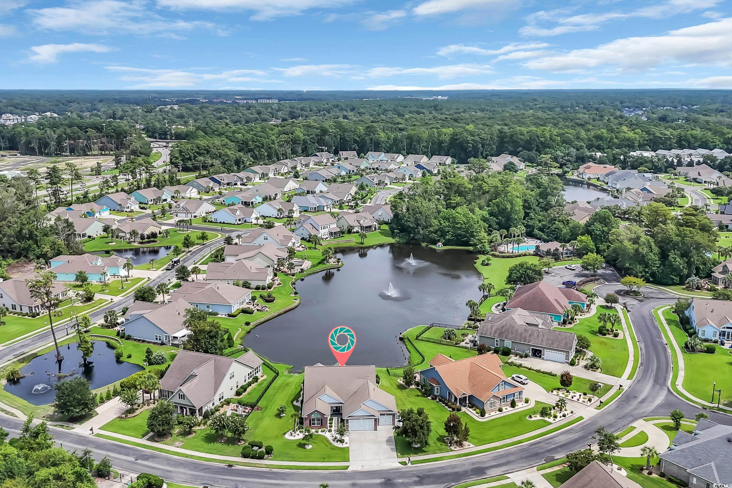Aerial view of property's location with nearby suburban area and a large body of water