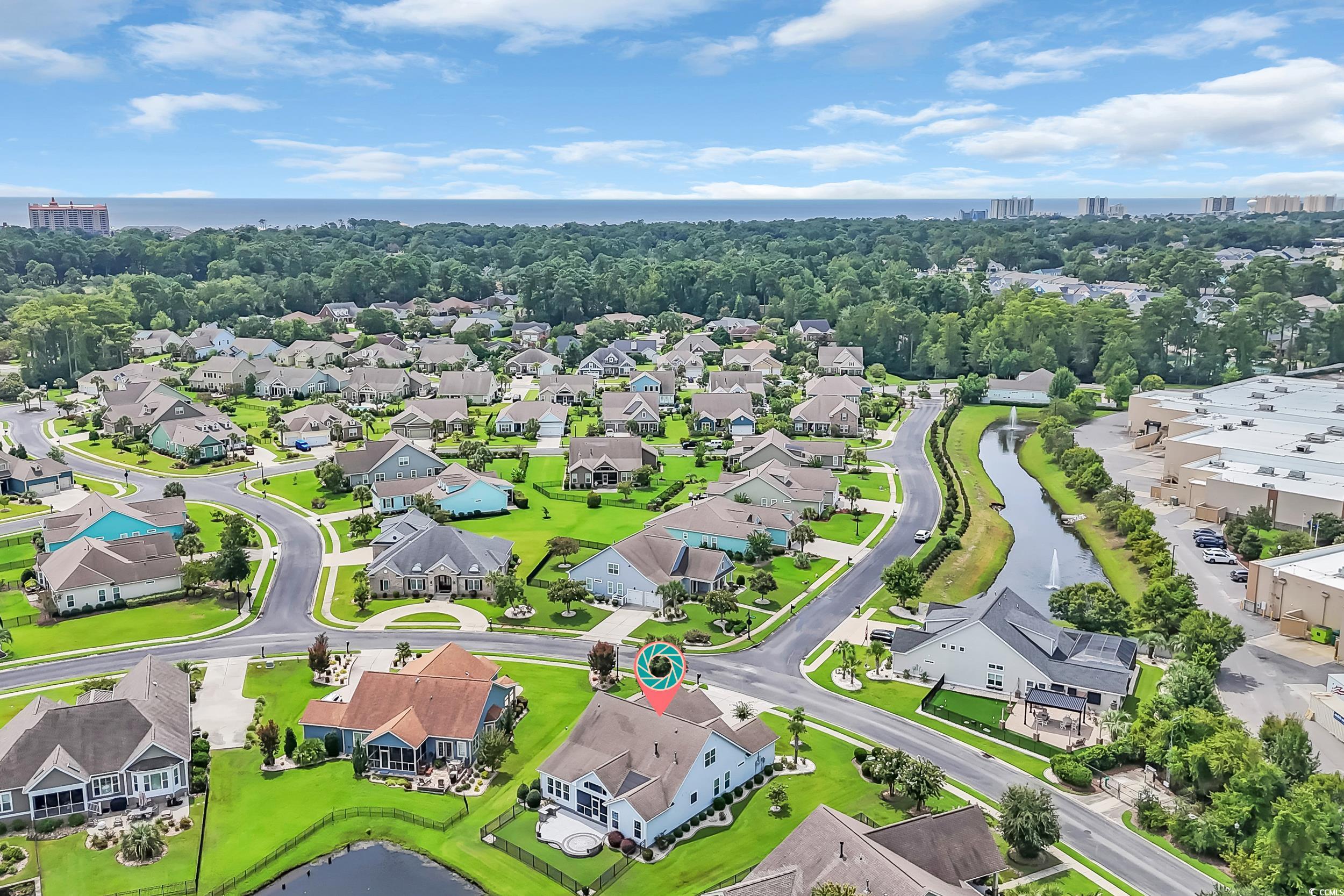 Aerial view of residential area featuring a large body of water