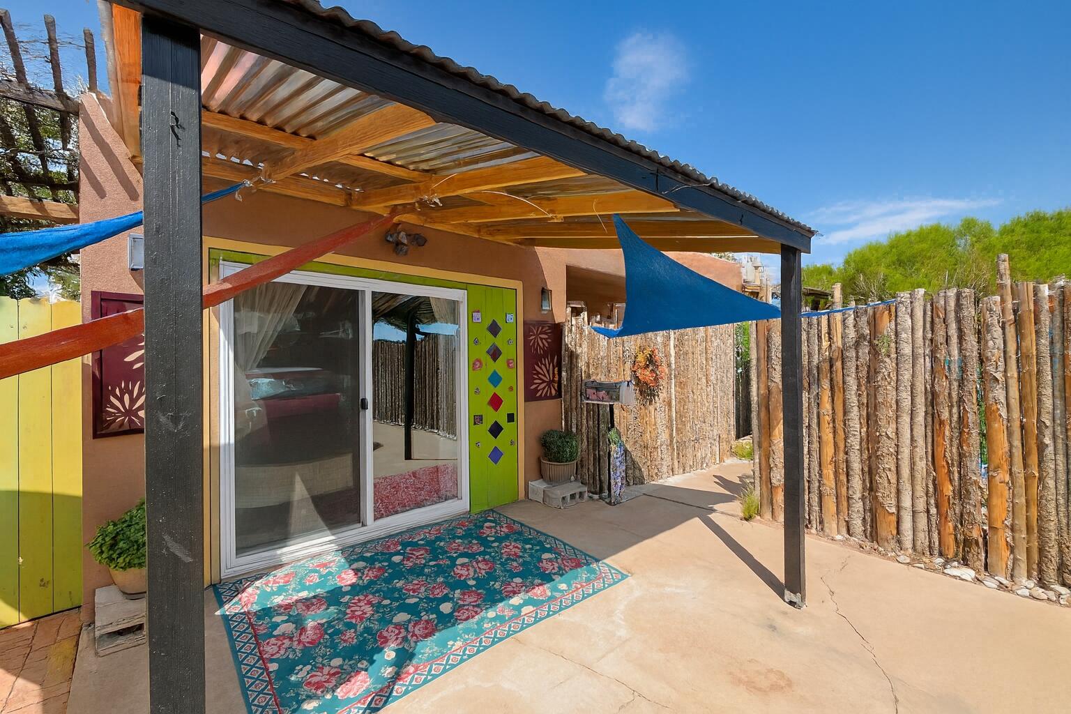 Welcome to this artist- and gardener-inspired retreat in Albuquerque's desirable Fair West neighborhood. Thoughtfully cared for and extensively upgraded over the past six years, the home showcases its original hardwood floors throughout, complete landscaping, solar, three mini-splits, three shade structures, a recent 6' cinder block wall, and newly installed 6' latilla fencing at the front and side. Major updates include a recent roof (2018), plumbing beneath the house (2024), a recent swamp cooler, and three custom gates. The garage has been converted into a bright den with sliding glass doors, while the bathroom offers an energy-efficient toilet, updated sink, resurfaced bathtub, and modern fixtures.