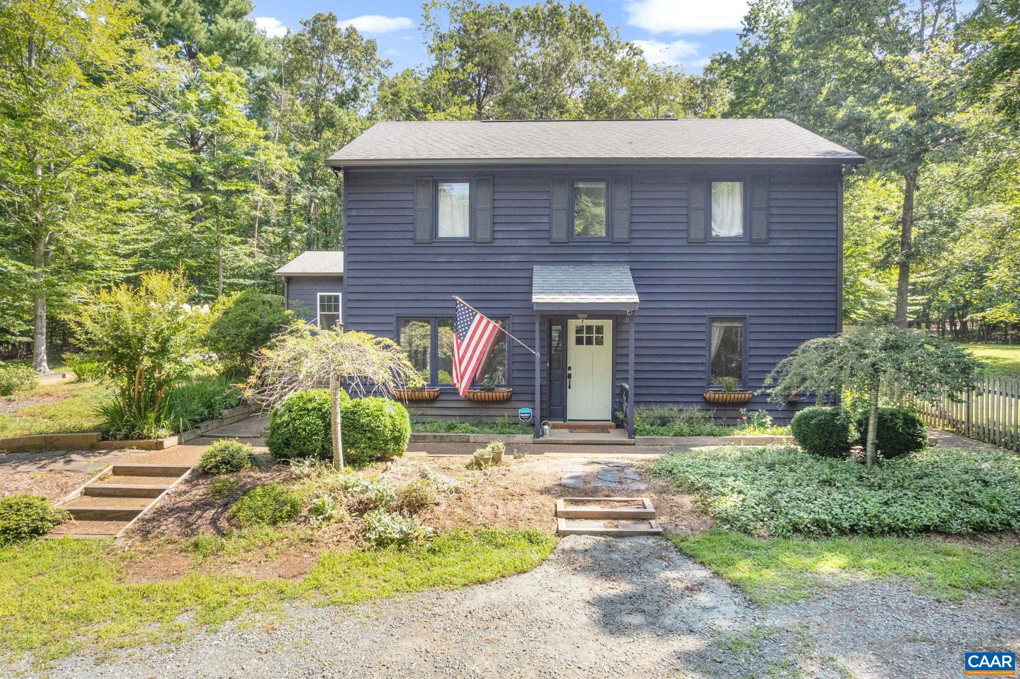Escape to your private sanctuary on 8 acres in Keswick! This welcoming 3-bedroom, 2.5-bath home offers abundant living space and has been thoughtfully updated by homeowners. As you enter the main level, the open living room with a wood stove invites you in, with a bedroom laundry/storage and half bath completing this floor. The heart of the home is a modern farmhouse kitchen featuring open shelving, and a large peninsula for casual dining. This space flows into a dining area, which opens into the garage. A versatile flex room with vaulted tongue and groove ceilings and skylights is adjacent to the family room. This space is perfect for a home office, playroom, or studio. The upstairs has two more bedrooms and two full, updated baths. Outside, enjoy the privacy of your expansive, fenced-in yard. There's plenty of space to meet anyone's needs, plus 8 acres of private land for gardening, chickens, and outbuildings to explore and use. Located just down from Stony Point Elementary, this home has been meticulously maintained with recent significant updates, including a new HVAC system, water heater, water filtration system, and more. This home is a private retreat waiting for you