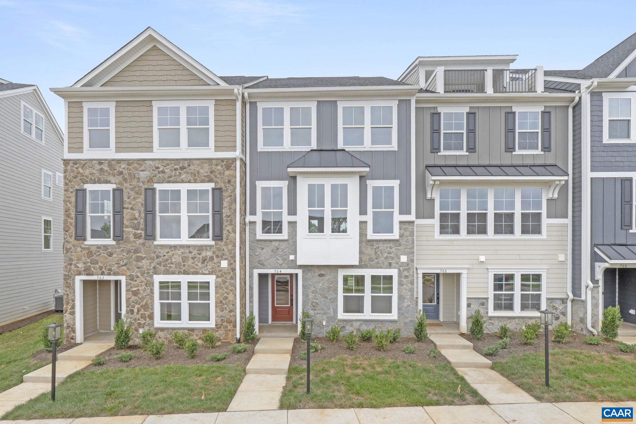 Just completed - actual photos! This Poplar II townhome in Glenbrook offers a comfortable, farmhouse-style layout surrounded by mountain views, green spaces, and walking trails—all within easy reach of downtown Crozet. This interior unit features a bright kitchen with plenty of prep room and a walk-in pantry, a spacious rear deck off the main level, and a first-floor bedroom with its own full bath that works well for guests or a home office. You'll find thoughtful touches throughout, like oak stairs, solid core interior doors, wood shelving, and an energy-efficient furnace. A two-car garage is included for added convenience. Community perks include a nearby path to Crozet Park and future access to downtown via a planned trail.
