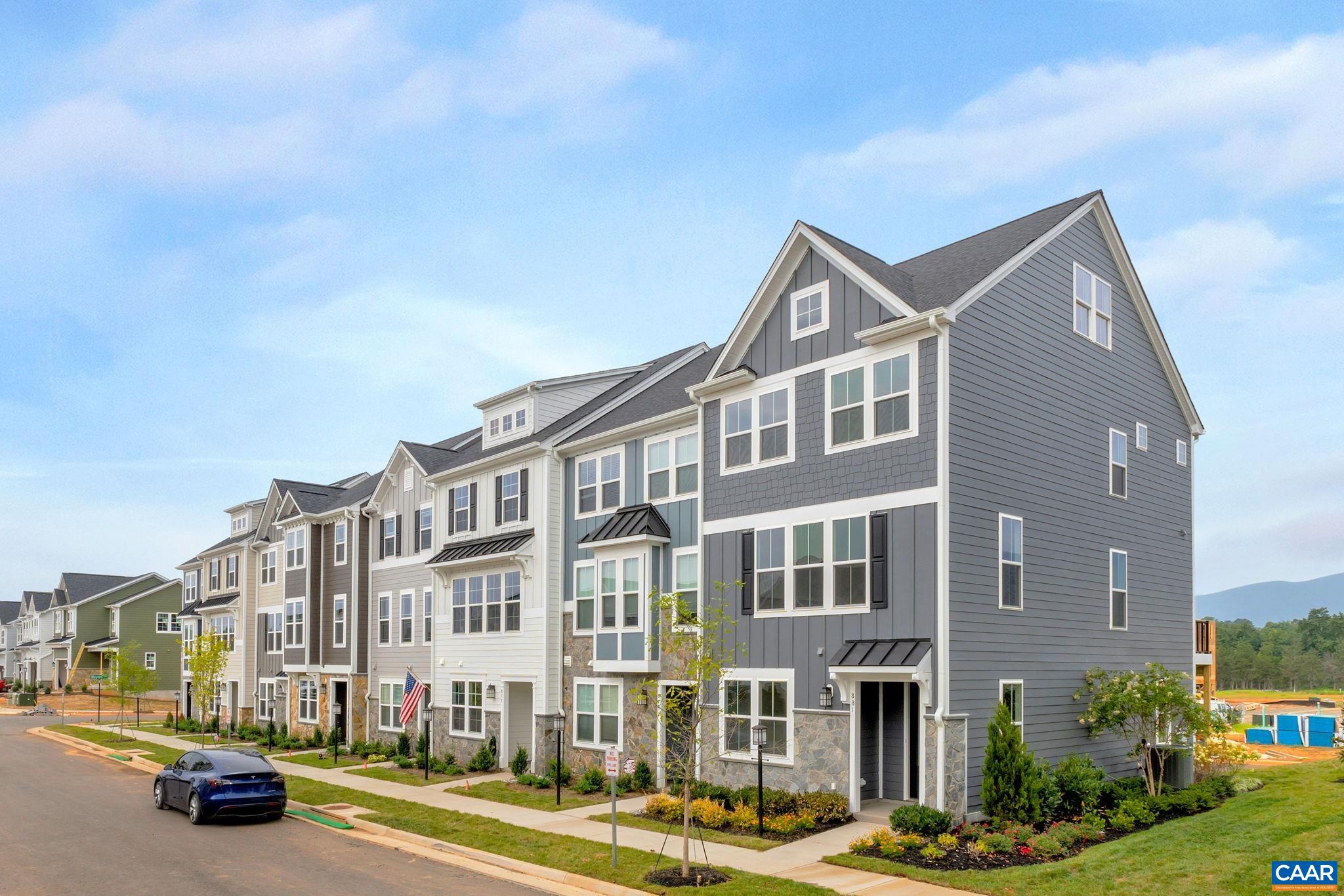 Discover the Holly II, a beautifully designed three-story townhome in the newest section of Belvedere. Fall '25 completion! This stunning home offers a spacious and flexible layout, starting with a rec room and half bathroom on the first floor, perfect for a gym, office, playroom or den. The second floor’s open-concept design features a large kitchen with a walk-in pantry, a generous dining area, and a sunlit family room, ideal for entertaining or everyday living, plus an additional half bath. Upstairs, the primary suite provides a retreat with a luxurious en suite bath, while two additional bedrooms share a well-appointed hall bath. The laundry is conveniently located on the third floor, making household tasks a breeze. Thoughtful upgrades like oak stairs with open railings and gas appliances add both style and functionality. A rear two-car garage offers parking and extra storage.  Belvedere offers an array of amenities, including access to parks, close proximity to the Rivanna trailhead, the nearby SOCA Fieldhouse, a dedicated dog park for pet owners, and enchanting playground areas.  Photos are of similar home and may show optional upgrades.