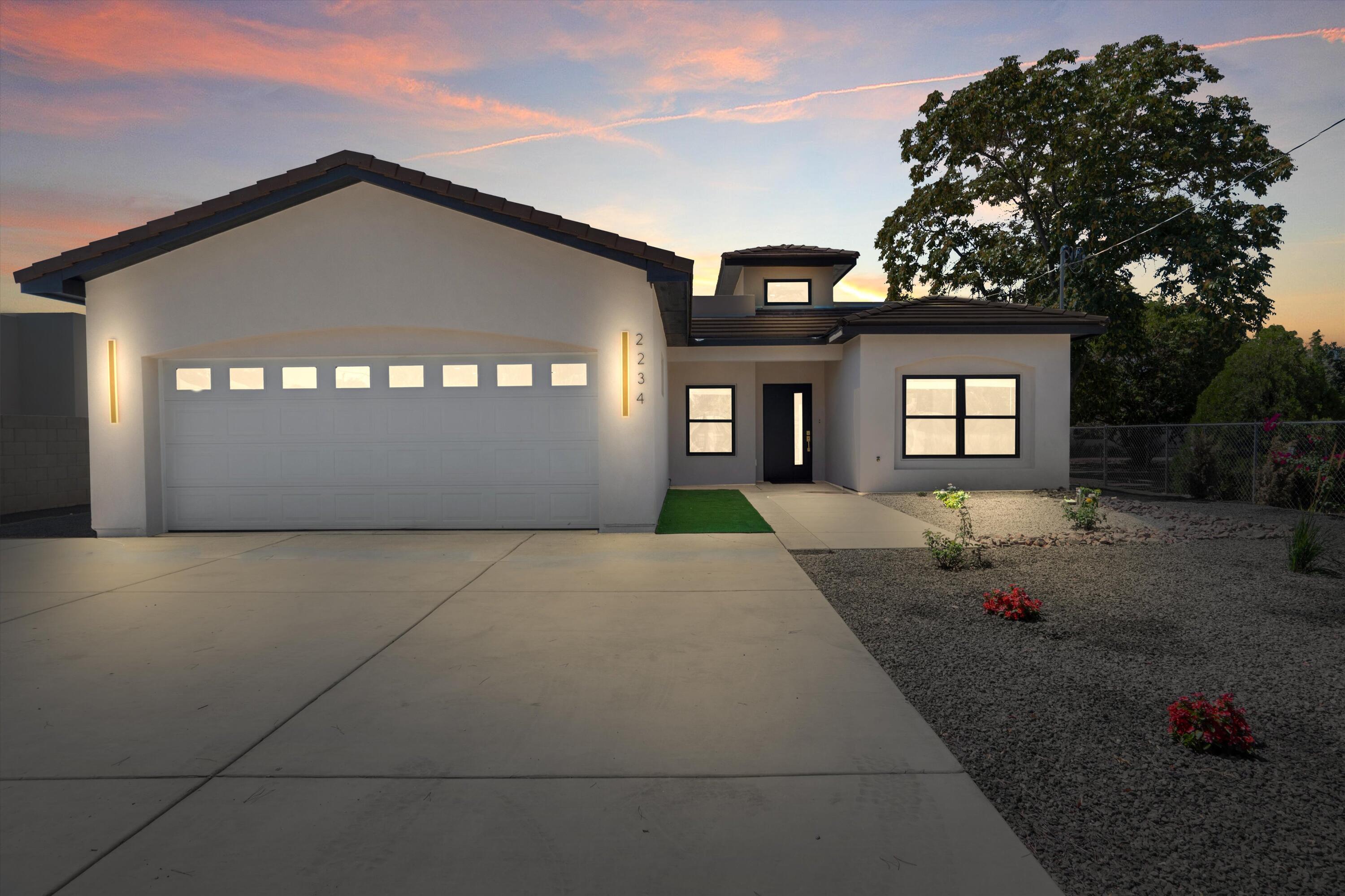 Chic contemporary custom home in the heart of the South Valley! Nestled on a spacious 1/3-acre lot with custom gate and side yard access. Step into soaring 15-ft ceilings that welcome you into an open floorplan designed for entertaining. The gourmet kitchen offers soft-close custom cabinets and a large island for gatherings. Featuring 4 generous bedrooms, the layout provides privacy while maintaining inviting common spaces. The luxurious primary suite boasts a spa-like bath with tub, separate shower, and walk-in closet.