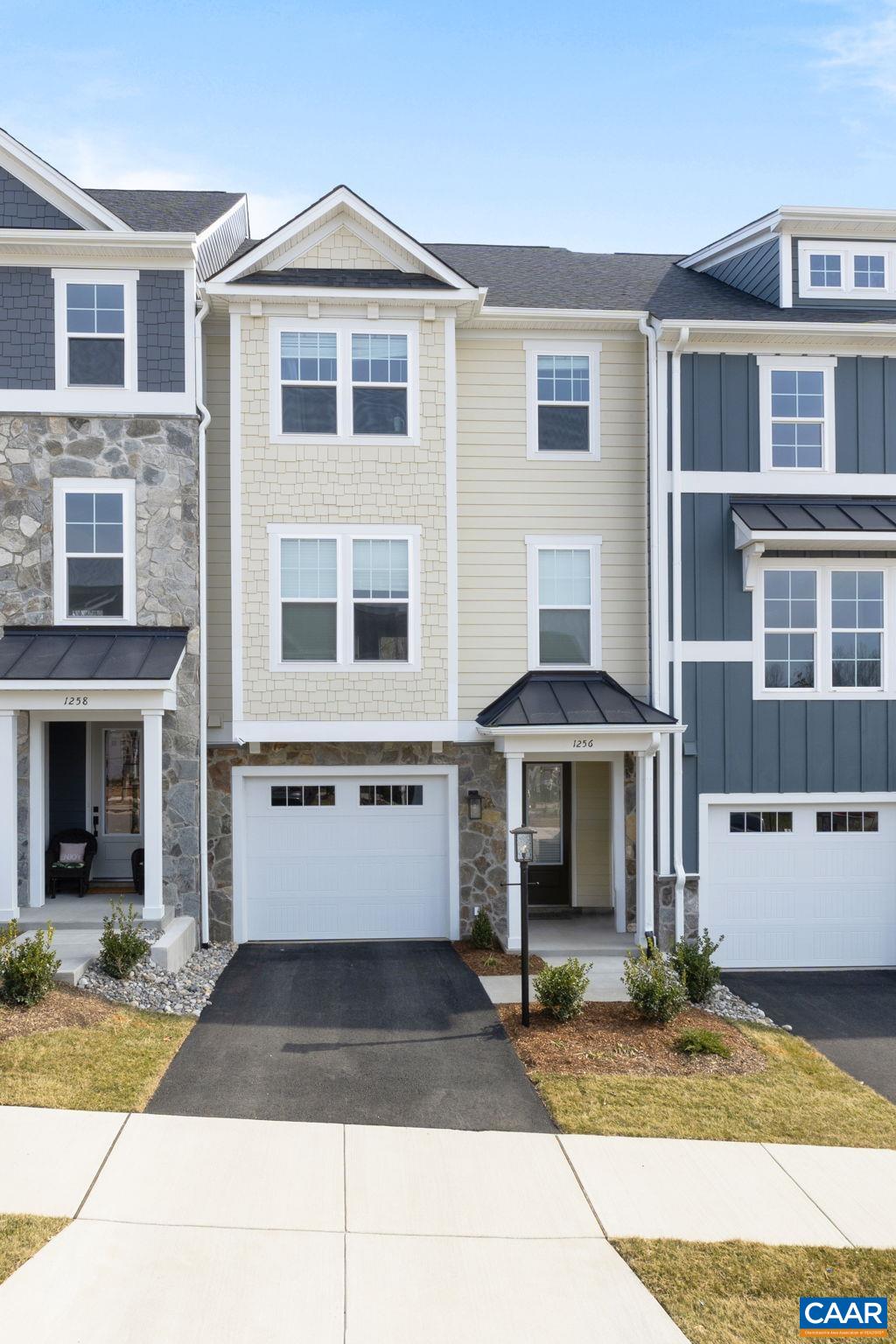 This Holly townhome in The Grove at Brookhill is currently under construction with a scheduled completion in December 2025. Located in a newly released section of the neighborhood with easy access to Route 29, this three-level home offers a smart, functional layout. The first floor includes a private bedroom with a full en suite bathroom and an attached 1-car garage. On the second floor, the open main living area includes a galley kitchen, dining space, family room, walk-in pantry, half bath, and access to the rear deck. The third floor features a hall laundry closet, a spacious primary suite with a large walk-in closet and private bath with shower, plus two additional bedrooms and a full bathroom. Pricing reflects all included structural options and interior design finishes. Photos are similar and may show optional features.