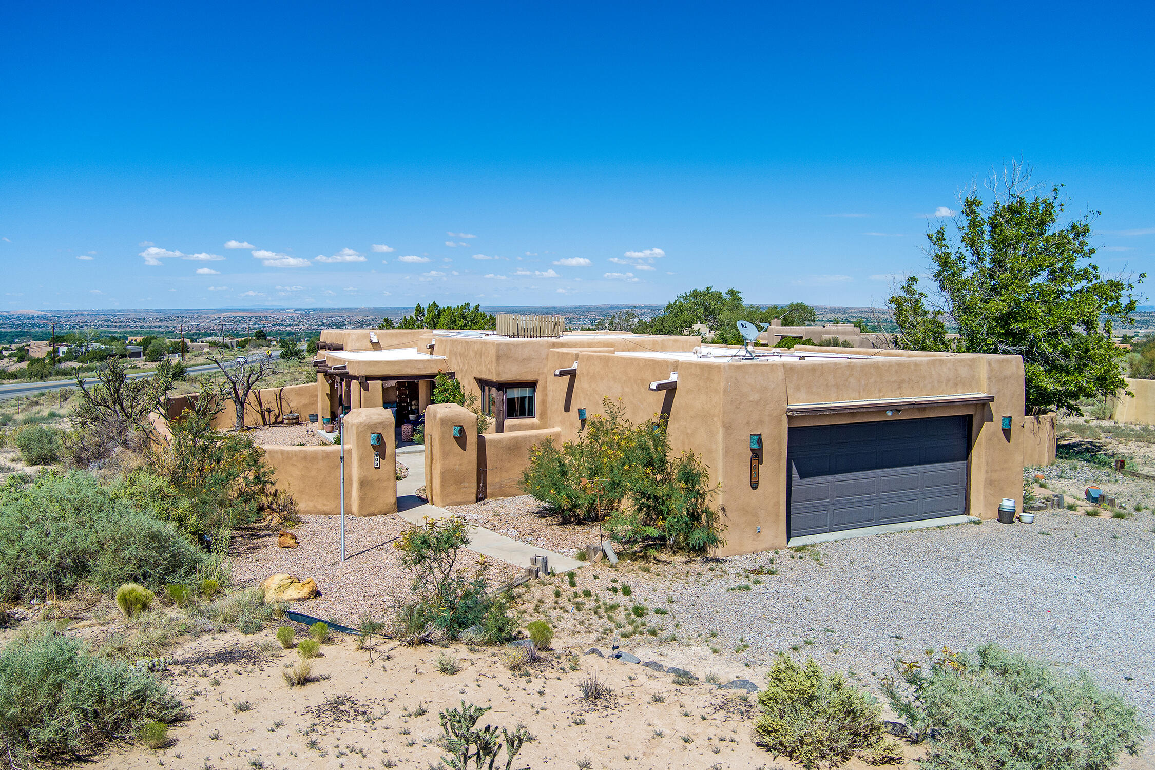 Amazing opportunity to own a custom adobe home in Placitas. Beautiful views of the Sandias and sunsets.  Home was custom built for the builders parents.  Covered portal entry. Kiva fireplaces, beams, lovely tile floors and SW accents enhance the home. TPO Roof, septic and other features updated in 2019. Open and bright floor plan with separated primary suite.  The bedrooms face north to back yard views and privacy.  Convenient commute to  Rio Rancho, Albuquerque and Santa Fe.