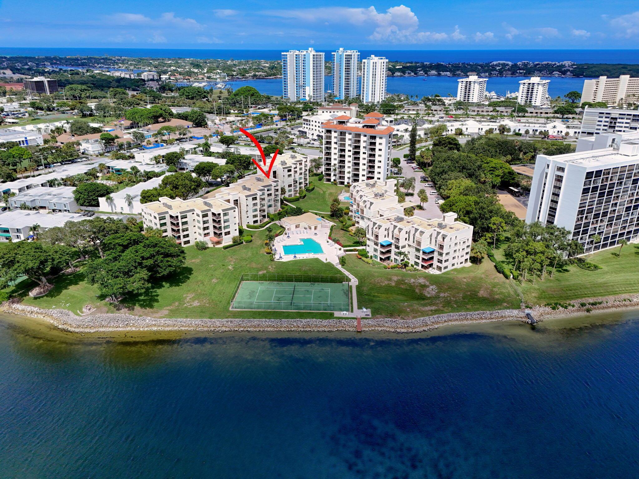 Spacious 2000+ sq. ft. corner unit overlooking the intracoastal, pool & North Palm Golf Course. Watch the boats go by and beautiful sunsets. Available fully furnished. Large rooms including a 20 x 14 foot primary bedroom, 21 x 14 foot living room and a 21 x 12 foot family room. Both bedrooms have large walk in closets and remodeled showers and the primary has double vanities. Washer & Dryer in the unit. Condo features Pool & Tennis. Accordion hurricane shutters for quick & easy protection from storms.Only 3 miles to the beach and walking distance to shopping & restaurants. New roof in 2024. Structural engineering inspections completed.