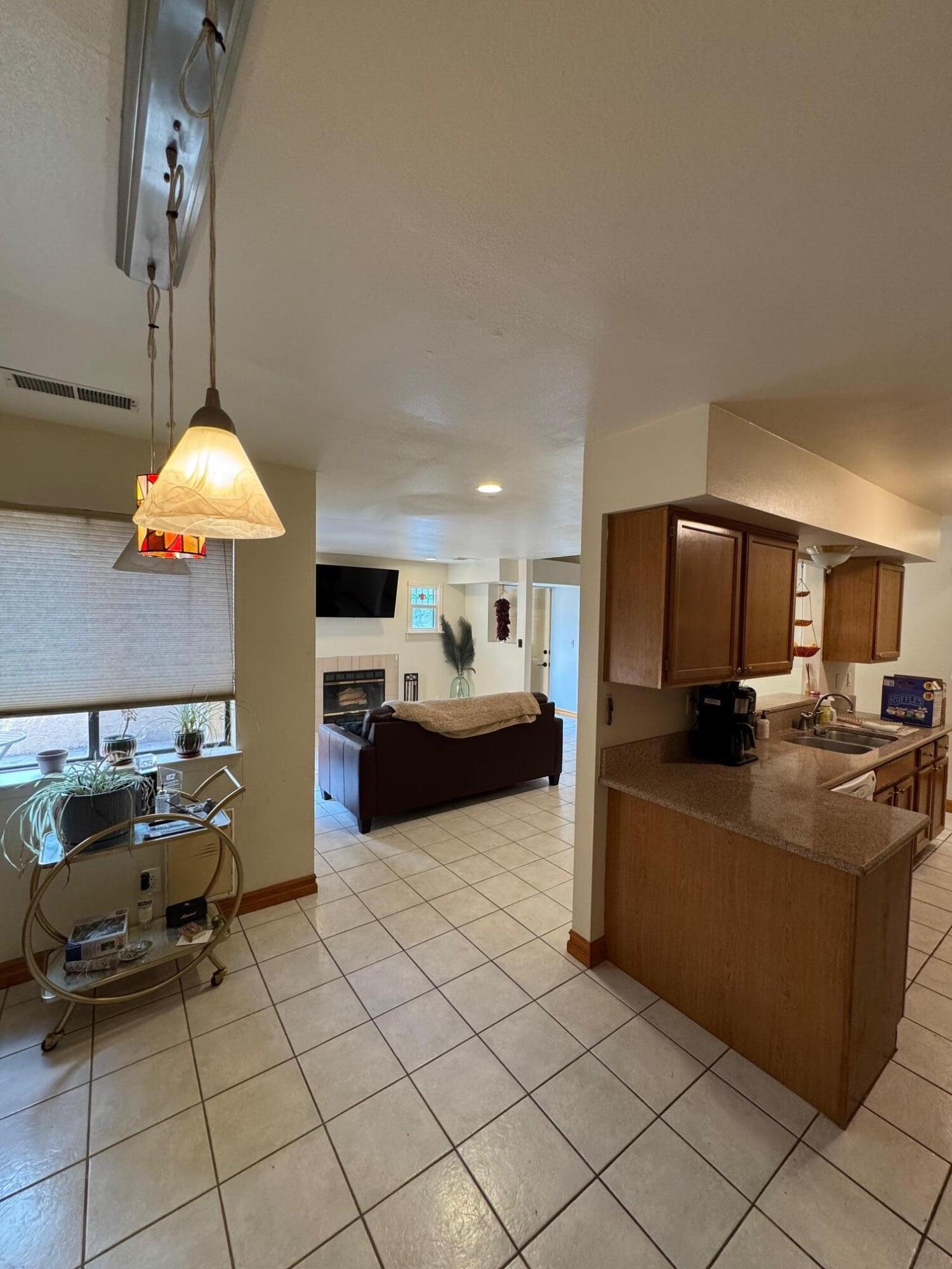 Roomy 3 BR home located in a quaint country cottage Eastridge Court neighborhood. Primary bathroom was recently renovated. New TPO roof over garage done last year and pitched shingle roof was replaced in 2021. HOA takes care of front landscaping.  2 Car Garage is tucked behind the house with parking also directly in front of the house. Owners' Suite located downstairs. Nice little patio space. Homes comes with all appliances and washer and dryer!