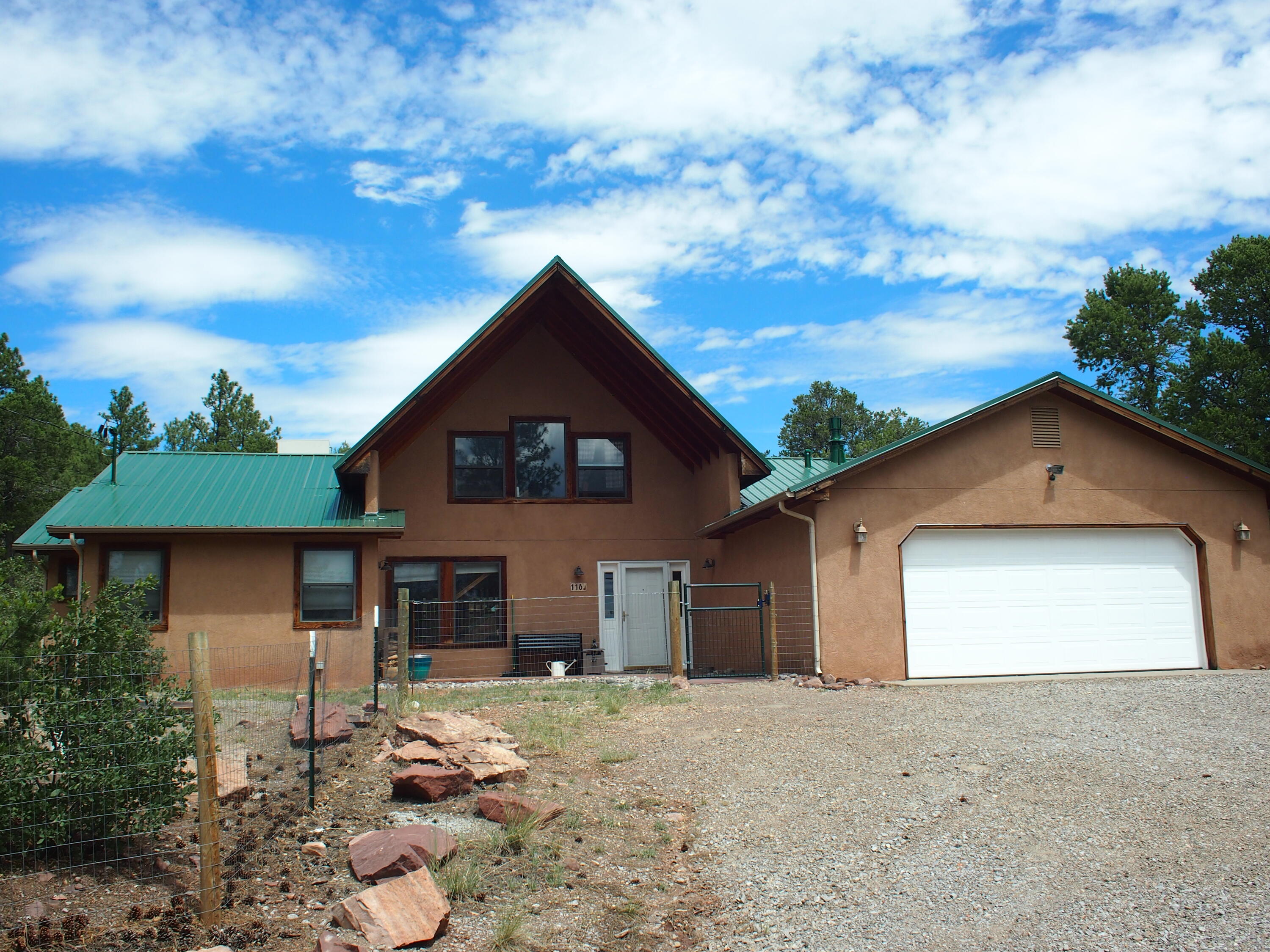 Beautiful Home on the Crest Hwy, in excellent condition, New metal roofing & carpet this summer. Just completed additional building with huge workshop and/or more garage space and 2nd floor living area along with heat and A/C, lots of room for projects or storage. Main home has wilderness behind and privacy. It  has all bedrooms downstairs, open floorplan combines living with a Lopi wood stove, dining, & kitchen w/ cathedral ceiling in most, Newish red oak wood floor plus tile and pantry in kitchen along with all modern appliances.  On 3 lots totaling over 1.9 acres behind a locked gate with Tinker Town across the highway and skiing, tubing, picnicking, hiking and the crest just up that road!