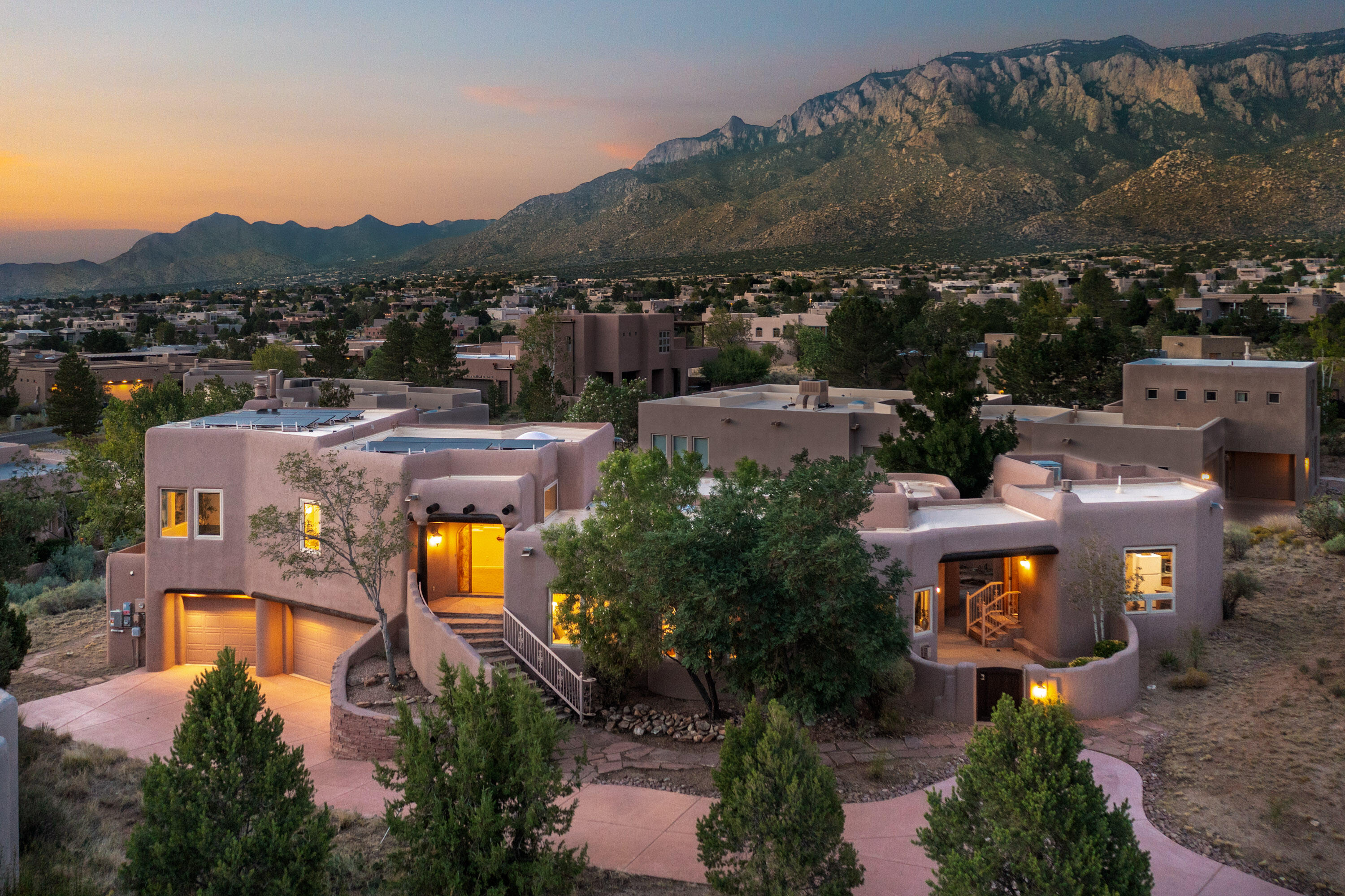 Experience the ultimate High Desert lifestyle in this incredible custom home showcasing breathtaking views of the Sandia Mountains and sparkling city lights. Surrounded by endless hiking, biking, and walking trails, this property perfectly blends natural beauty with comfort. The main home radiates Southwestern charm with gorgeous beamed ceilings and a bright, open floor plan designed to capture the views from every angle. The kitchen features custom cabinetry, stainless steel appliances, and rich granite countertops.  A detached casita offers exceptional versatility with its own living area featuring a cozy kiva fireplace, full kitchen, and private bedroom with en-suite bath--ideal for guests or multi-generational living. An oversized 3-car garage completes this exceptional property.