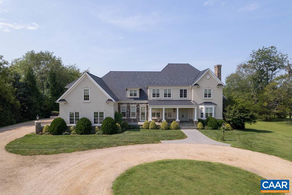 In the heart of Keswick Estate, this remarkable residence brings together scale, design, and setting with more than 9,000 finished square feet, 5 bedrooms, 7 full baths, and 2 half baths. A dramatic entry hall introduces refined living and entertaining spaces, while the chef’s kitchen and breakfast room flow seamlessly to slate terraces overlooking manicured grounds and the fairways of Hole 3 at Full Cry. The main-level primary suite offers a private retreat with dual closets, sitting area, and spa-like bath. Upstairs, three ensuite bedrooms and a bonus room provide generous accommodations, complemented by a terrace level with media room, game room, bar, and additional suite. A home gym, saltwater indoor pool, spa, and sauna form the home’s wellness centerpiece. Beyond the property itself, life in Keswick Estate affords a rare connection to Keswick Hall, where world-class dining, championship golf, and resort amenities combine with the privacy of an exclusive gated community. Just minutes from Charlottesville yet entirely private, the estate offers Blue Ridge views, quiet sophistication, and seamless access to UVA, Virginia’s wine country, equestrian venues, and cultural landmarks.