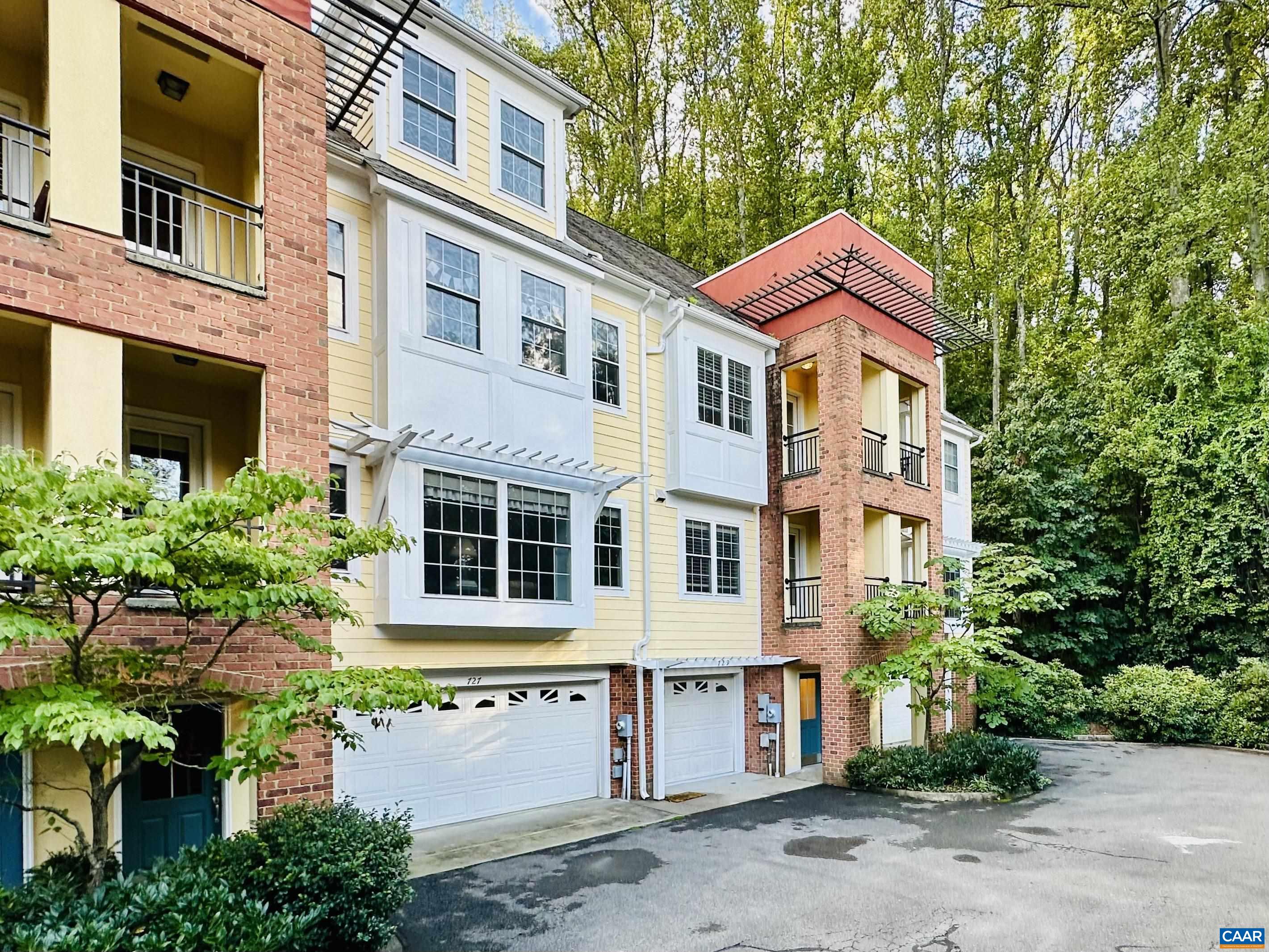 Move-in ready and freshly updated in a prime UVA location just behind the UVA Orthopedic Center! Just-completed upgrades include a brand-new HVAC system, fresh paint throughout (trim, walls, ceilings, and garage), a stylish custom tile shower in the primary bath, updated light fixtures, and a newly epoxied garage floor. This upscale luxury townhome offers an open-concept kitchen and great room with a cozy gas fireplace framed by built-ins, plus a private brick patio with landscaped surroundings. The entry level features a welcoming foyer, spacious tandem garage with extra storage, and a full laundry room. Enjoy the best of both worlds—close enough to walk to UVA while still savoring the peace and quiet of private living.