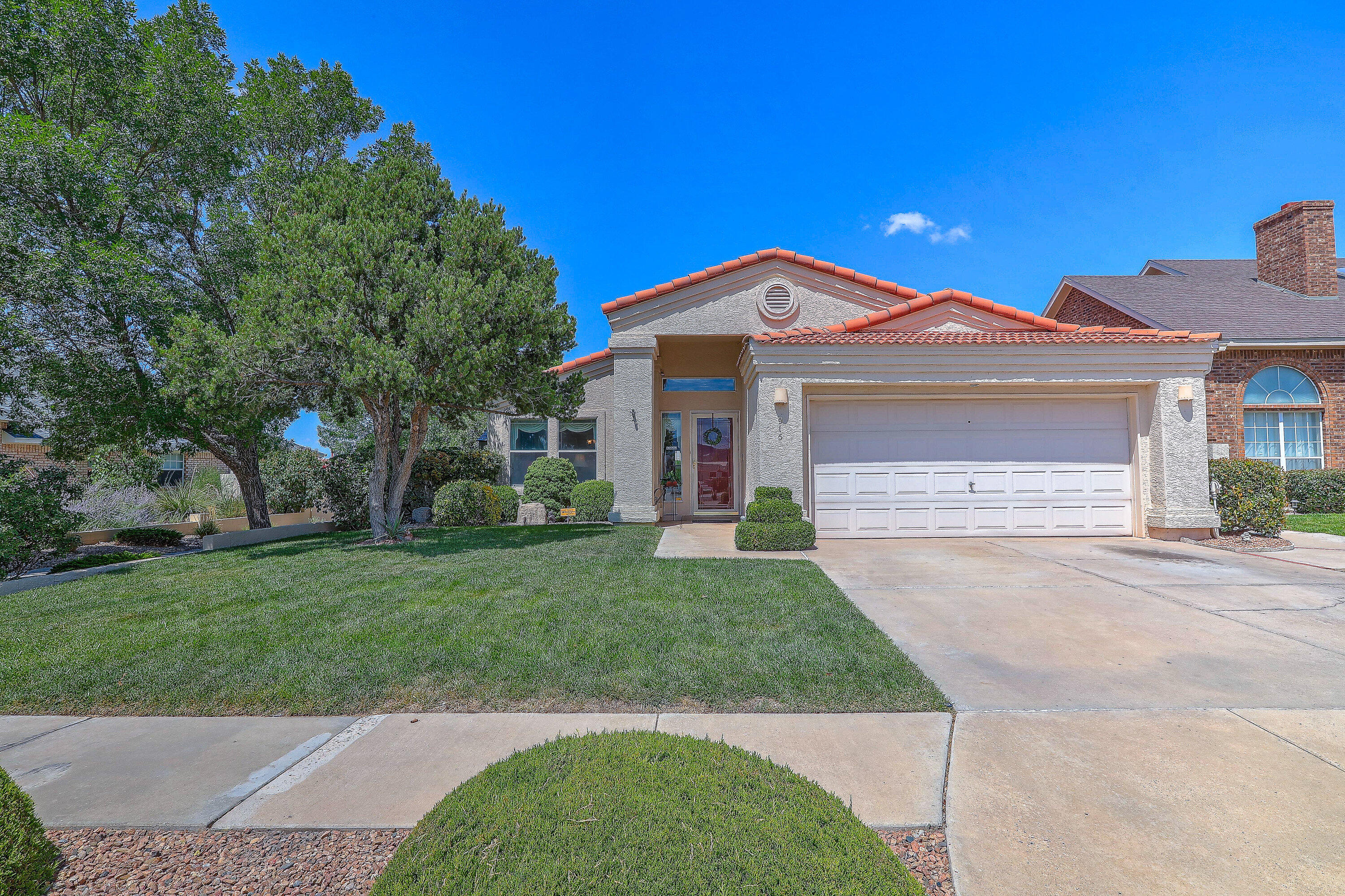 Move in ready home in Willow Wood! You will love this meticulously cared for property that is conveniently located close to KAFB, Sandia Labs, shopping and restaurants with Pickle Ball Courts and Open Space Trails nearby!  Open and bright with great floor plan, NO CARPET, beautiful engineered wood flooring.  Two living areas, family room is open to kitchen and has gas fireplace and patio access.  Kitchen has granite counters, island, gas stove, lots of storage and all appliances convey!  Spacious primary bedroom has corner electric fireplace which conveys, bathroom with soaking tub, separate shower, double sinks  and huge walk in closet. Lush backyard with two garden sheds, auto sprinklers/drip system, peach, apple, plum trees and grapes!  Perfect for your gardening and relaxing.