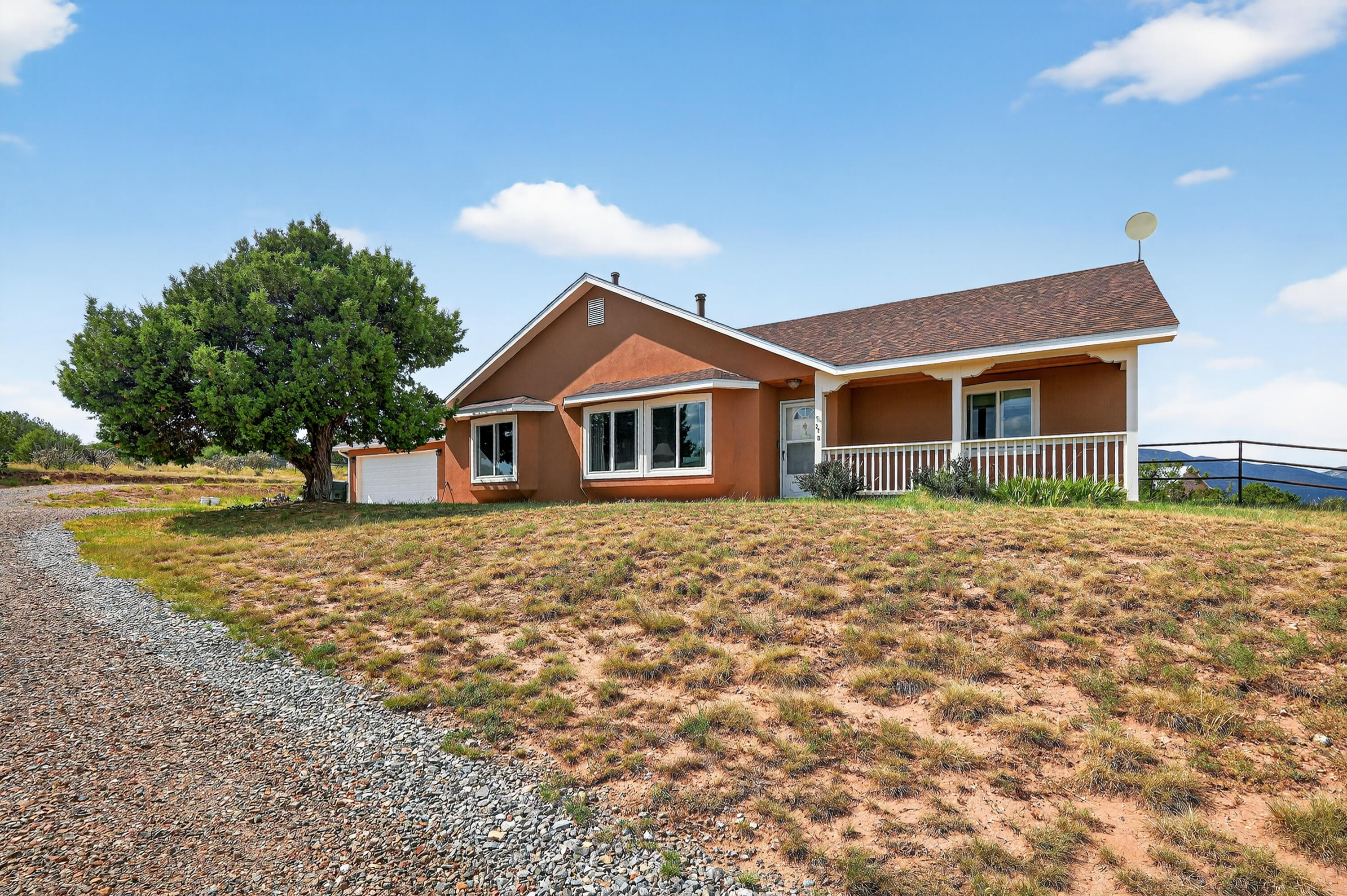 Welcome to this charming three-bedroom, two-bathroom home nestled in the East Mountains on 2.5 acres with breathtaking mountain views, stunning sunrises, and unforgettable sunsets. Perfect for horse enthusiasts, the property features a 48x36 barn with four stalls, three turnouts, horse pipe fencing, a wash station, and 100-amp power. Recent updates include new stucco and windows (2023), a new roof (2024), and an updated kitchen with a customized island and newer appliances. The master suite offers an updated bathroom featuring unique horse tile murals. Beautiful ceramic tile flooring flows throughout the home. Additional highlights include a two-car garage, newer dishwasher, and a furnace/water heater only 10 years old.Don't wait schedule your tour today!