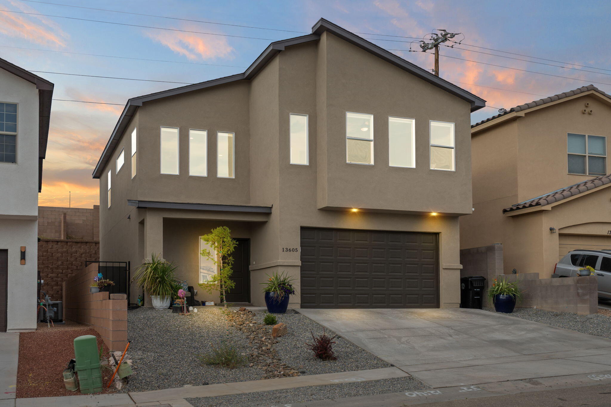 Experience modern elegance and quality craftsmanship in this stunning open-concept custom home featuring a soaring 20' entryway, quartz countertops, stainless appliances, raised panel doors, and an upstairs laundry for convenience. Energy efficiency shines with a tankless water heater, Carrier furnace, refrigerated air, and large low-E windows. Enjoy a fully landscaped front and back yard plus beautiful views. Conveniently located in North Four Hills, trails, Kirtland Airforce base, shopping, and dining at 10 minutes from uptown. With a 1/2/10 Builder's Warranty for lasting peace of mind.