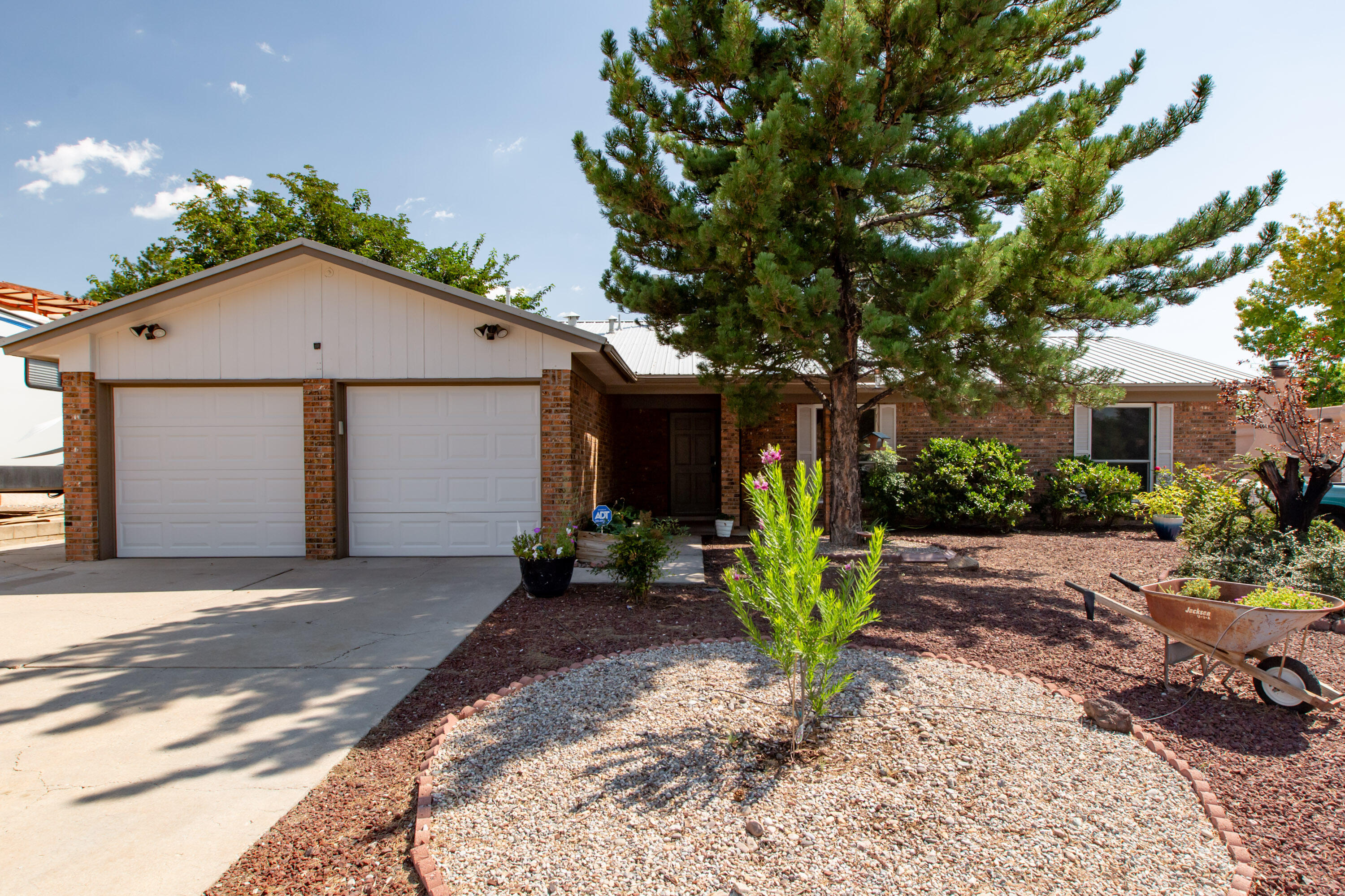 Welcome to this beautifully updated home in the highly desirable NE Heights! Freshly painted with new tile in the kitchen and baths, along with updated laminate flooring, this home is move-in ready. The spacious great room boasts a cozy fireplace, vaulted ceilings with beams, and abundant natural light. The kitchen features trendy black cabinetry, stainless steel appliances, and a modern feel. Retreat to the backyard with a covered patio, perfect for entertaining or relaxing. Major upgrades include a metal roof (2019), re-stucco (2023), and refrigerated air (2021). Located within the sought-after Dennis Chavez, and La Cueva school districts and close to great shopping, dining, and entertainment, this home offers both comfort and​​‌​​​​‌​​‌‌​‌‌‌​​‌‌​‌‌‌​​‌‌​‌‌‌ convenience.