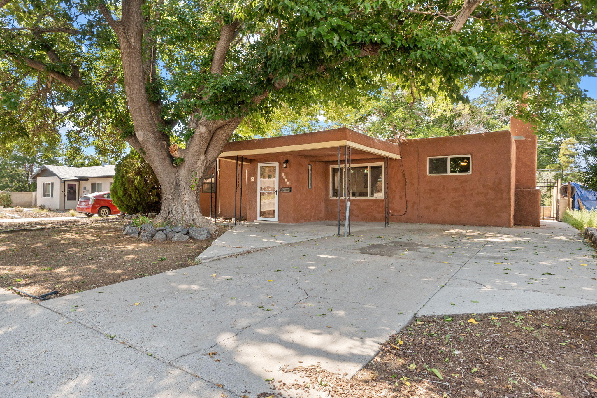 Recent roof, refrig air (mini-splits heat and cool), new carpet, and fresh paint make this home ready for move in! Great NE heights neighborhood and convenient location! This cute home sites under beautiful shade trees, with a HUGE backyard. Walk to a number of great local restaurants and ABQ Coffee in The Albuquerque Collective! This is a great little starter home with a large living space with wood burning fireplace covered patio and large yards/trees make for great outdoor living and tons of potential!  Best value in town at this price, see it now before it sells!
