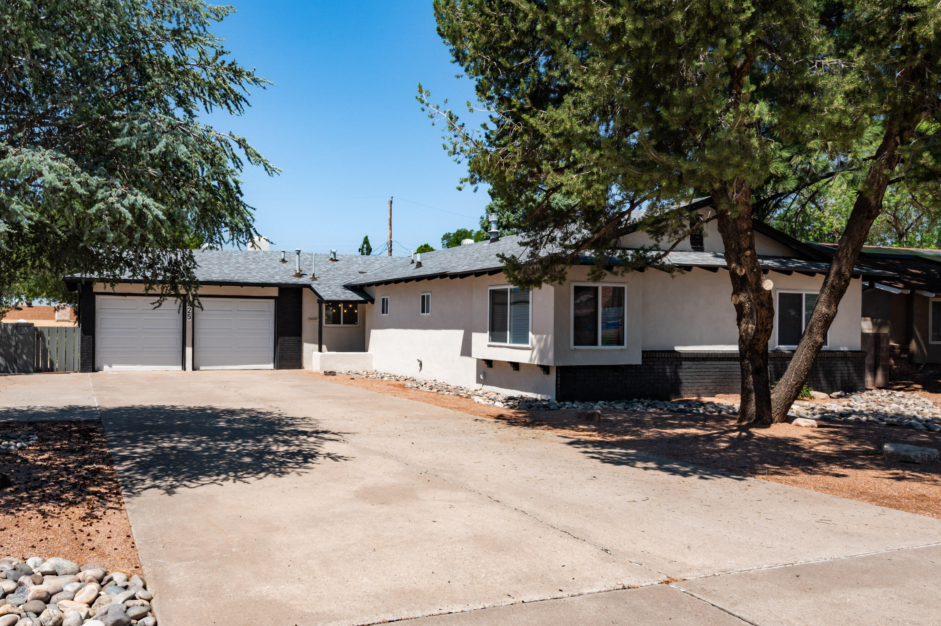 Completely remodeled 3-bedroom, 1.75-bath home in Albuquerque's Northeast Heights! Updates include new roof, stucco, paint, water heater, electrical panel, HVAC, windows, and flooring throughout. The stylish kitchen features new soft closed cabinets, island, and stainless-steel LG appliances--including washer & dryer. Enjoy two living spaces including a fireplace and plantation shutters. Stay comfortable year-round with refrigerated air! The landscaped backyard offers privacy fencing for outdoor living, plus a 2-car garage for convenience. Centrally located near shopping and restaurants, this move-in ready home blends modern updates with everyday comfort.