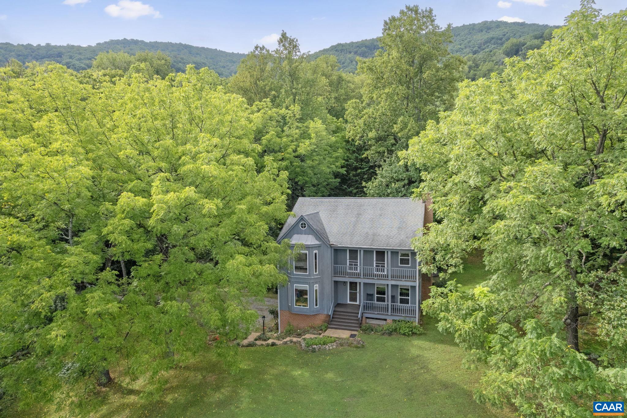 Mountain(s), birds, and nature abound! DOUBLE FRONT PORCHES with commanding vistas have space for rocking chairs. Enjoying morning coffee or evening glasses of wine has never been easier. PRIVACY in this BEAUTIFULLY MAINTAINED home, offering you peace of mind with major updates done: all Quest plumbing replaced, water heater (2022), Two HVAC systems including NEW MAIN LEVEL UNIT (2025), roof boots replaced, 2023 new range. Ceiling Fans in Every Room. Upgraded electrical outlets in the basement WORKSHOP. No worries here with reliable buried electric service. Enjoy outdoor living with many stone accents, a productive garden, and a RELAXING SCREEN PORCH. Just minutes away, 520-acre Mint Springs Park offers miles of trails, 8 acres of water, and stocked fishing and many amenities. Crozet Park features swimming, yoga, water aerobics, baseball and community festivals. King Family Vineyard and polo are nearby, with easy access to I-64 and Rt. 250 (10 minutes) and Charlottesville just 25 minutes away. 3 miles to heart of Crozet with a wonderful public library. Many Orchards, wineries, farmer markets nearby. Annual HOA fee is $350. Please DO NOT drive down the driveway without a confirmed appointment. Can close quickly.