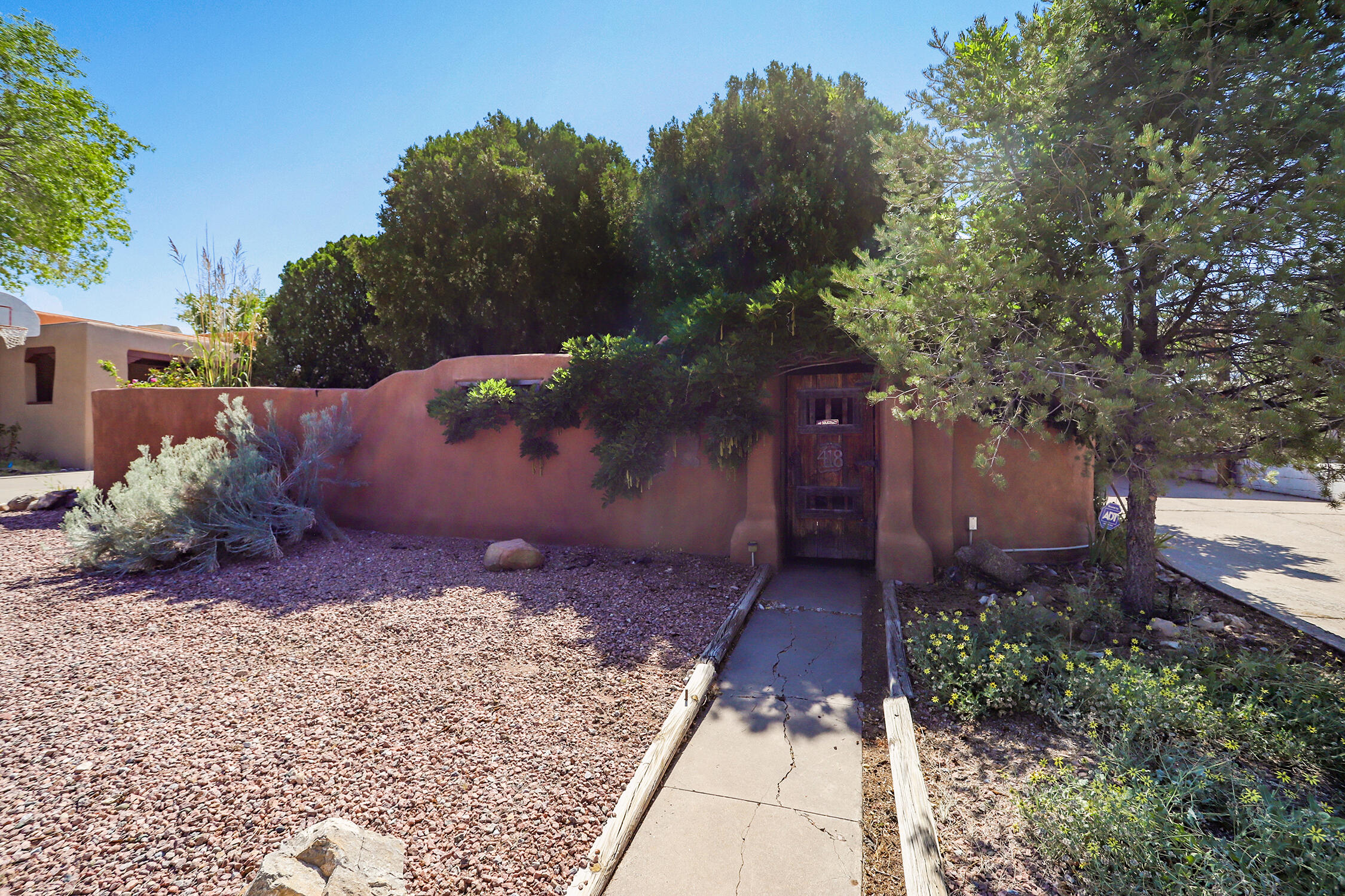 Charming 3-bedroom, 2-bath home just minutes from UNM! This versatile property features a private lock-off suite--ideal as an in-law space or income-producing rental. Enjoy warm wood floors, a spacious workshop, and two storage sheds for all your needs. Relax in the peaceful courtyard or the beautiful backyard. A rare find combining comfort, flexibility, and unbeatable location!