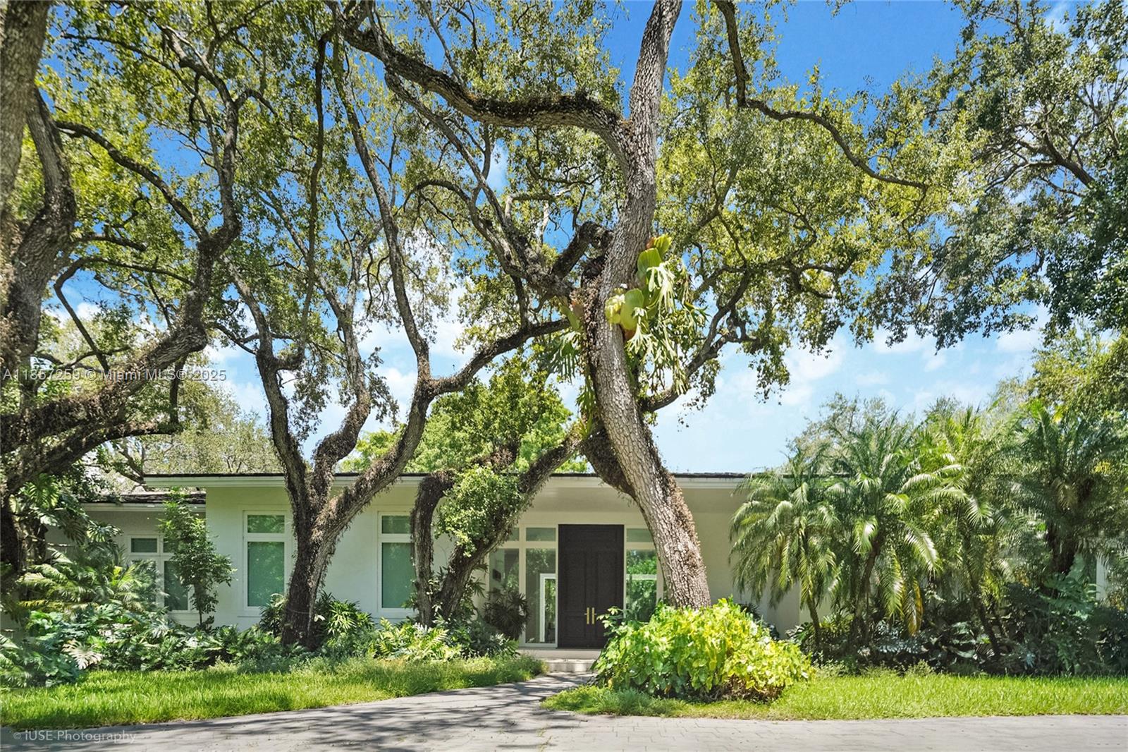 Set on a rare, oversized 56,192 SF lot in one of Coral Gables’ most coveted communities, the prestigious, guard-gated Snapper Creek Lakes offers serene seclusion, lush landscaping, a private marina & naturally elevated terrain. Built in 2021 with meticulous craftsmanship & finishes of the highest caliber. Soaring 12-FT ceilings flood the interiors with light that instantly impresses. Surrounded by greenery, & framed by abundant windows, & expansive gallery-style walls, the functional layout features 6 ensuite bedrooms, 6 full & 2 half baths, chef’s kitchen with dual islands & a private primary wing with office, spa bath, & indoor/outdoor showers. Expansive glass doors lead to a resort-style pool, covered terrace, & space for tennis court, 3-car garage, mudroom, dual laundries & generator.
