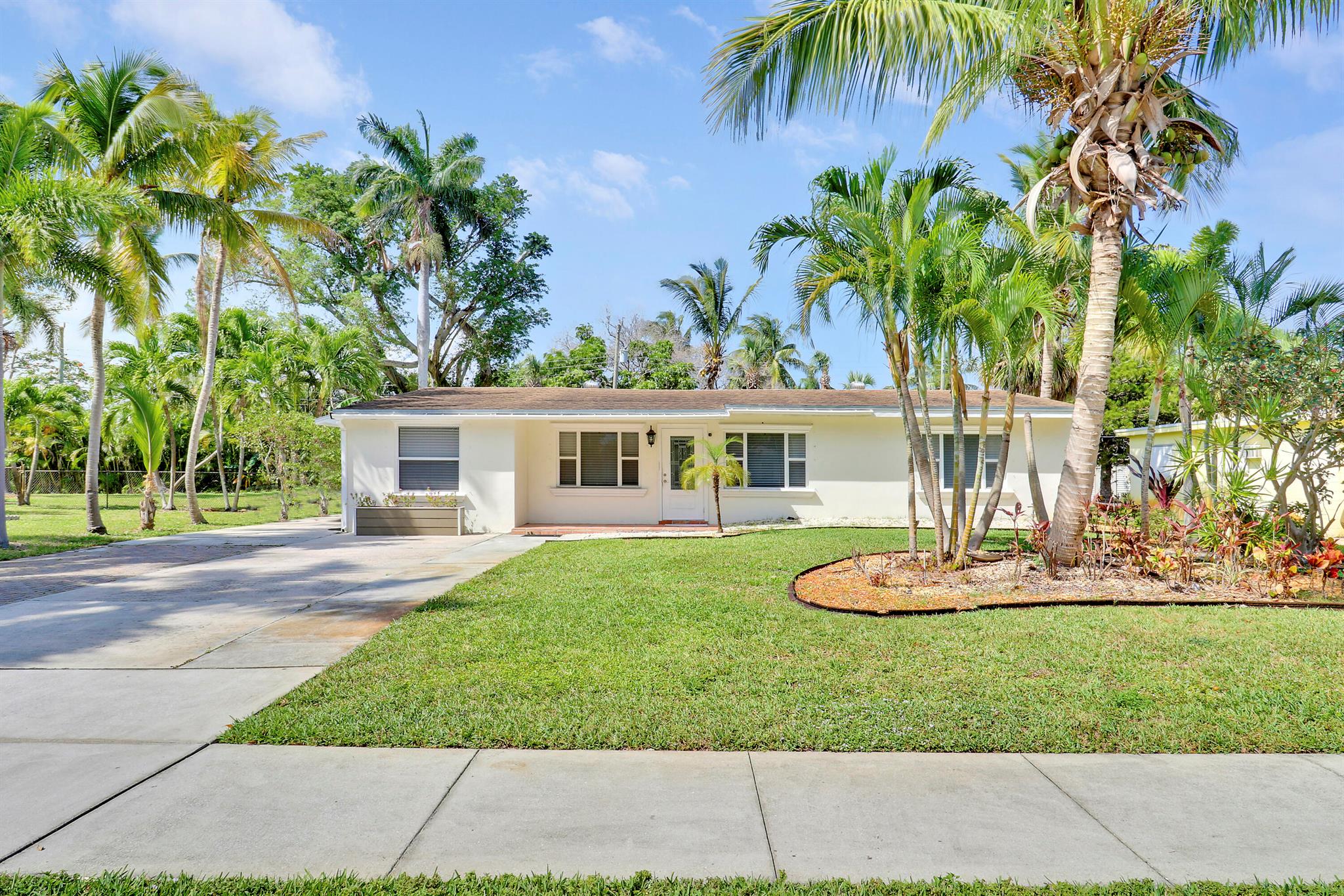 Step into this delightful 3-bedroom, 2-bathroom gem, perfectly nestled on a spacious corner lot in the heart of North Palm Beach. This home is a true blend of comfort, style, and convenience, offering everything you need to embrace the Florida lifestyle. Inside, you'll find a bright, open floor plan with tile flooring throughout, creating a fresh and inviting atmosphere. The updated kitchen is a showstopper, featuring sleek granite countertops, stainless steel appliances, and plenty of space to whip up your favorite meals. The expansive backyard is your personal oasis--perfect for hosting unforgettable gatherings, starting your dream garden, or even adding a pool. And with no HOA, you have the freedom to make this space truly your own.