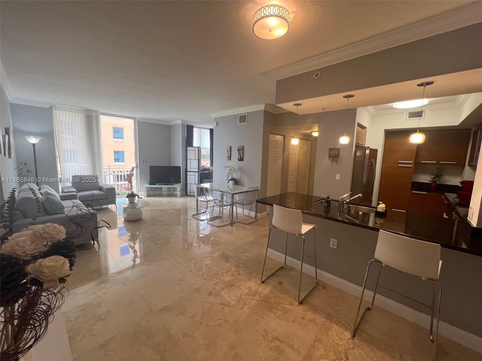 Three Bedrooms (one of the bedroom is a large den with window and closet), two walk-in closets, washer and dryer inside, and an open kitchen with granite countertops and stainless steel appliances. This residence also features a private balcony with a gorgeous city view. Located in the heart of Coral Gables, the renowned "City Beautiful," this 2005-built apartment combines modern comfort and elegance. It is surrounded by excellent restaurants, schools, and hospitals—many within walking distance—and offers luxurious amenities such as a swimming pool, clubhouse, jacuzzi, gym, and more. The unit includes two parking spaces and guest and 24/7 security, rentals are allowed anytime, providing great flexibility. A perfect place to enjoy the charm and convenience of Coral Gables.