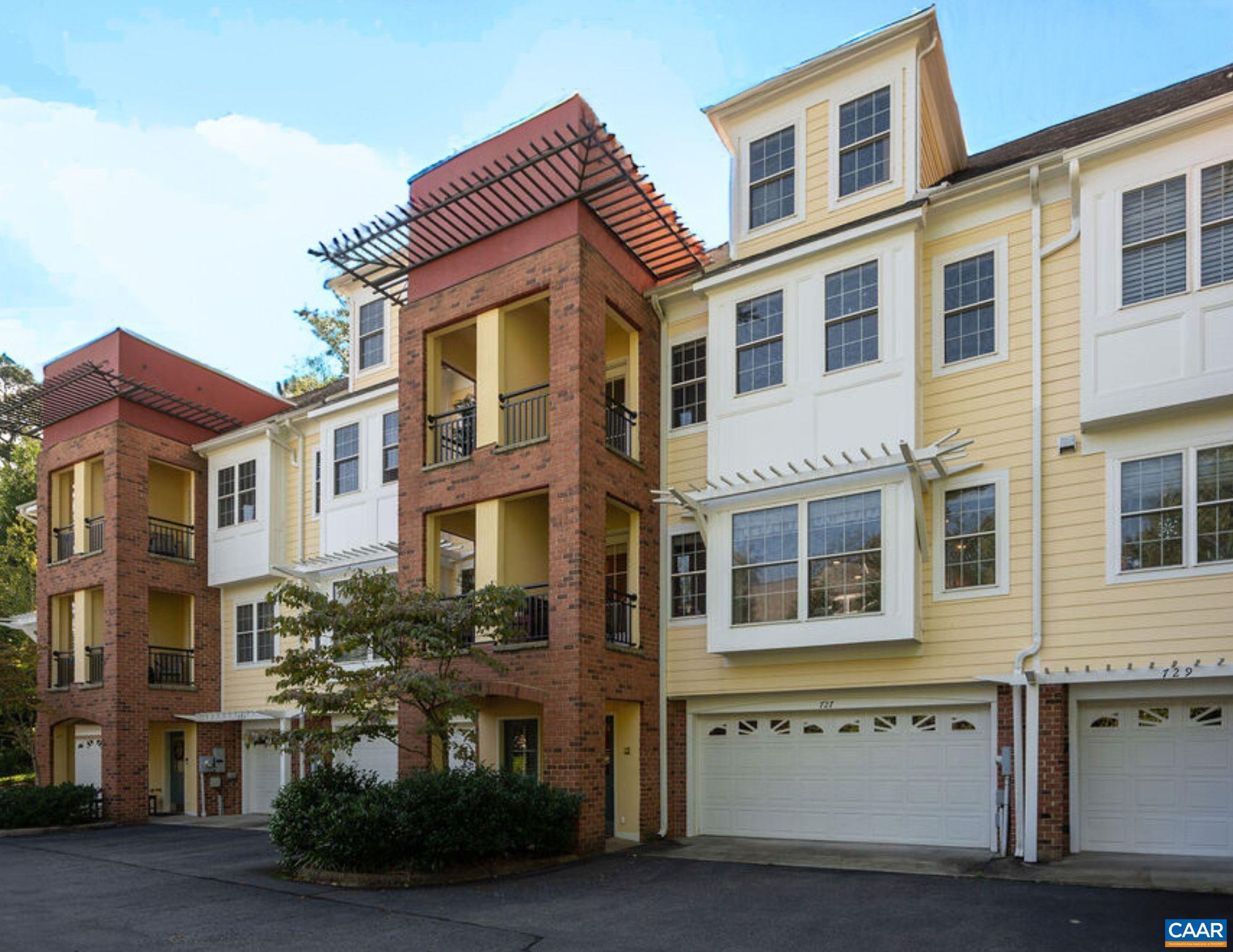 Don't miss this elegant, spacious townhome (with elevator) just minutes to UVa, near all of the conveniences just west of Grounds, but tucked away in a quiet, leafy neighborhood. This pristine 4 bedroom home offers high end finishes & gracious, well proportioned rooms. Enter into a lower level foyer, beside a 2 car garage & large storage/bonus room (currently used for exercise). On the second floor, find generous living & dining rooms, a large, upscale kitchen, powder room, hardwood floors, a two sided fireplace, a peaceful back patio & a front balcony. On floors 3 & 4 are the primary suite plus 3 other bedrooms & 2 more full bathrooms, another terrace, a laundry room and generous closet space. Don't miss the Blue Ridge view from the 4th floor front bedroom (currently used as an office). These views are more prominent in winter. The Rivanna Trail, restaurants, groceries, commuter routes are close by. Easy stroll to the JPJ, Scott Stadium, Grounds, restaurants & shops. This is low maintenance living at its best. HOA covers much exterior maintenance (except windows & doors). This home was just painted on the outside, and the inside (including the kitchen cabinetry) was painted in the last 5 years. See floorplans & features in docs.