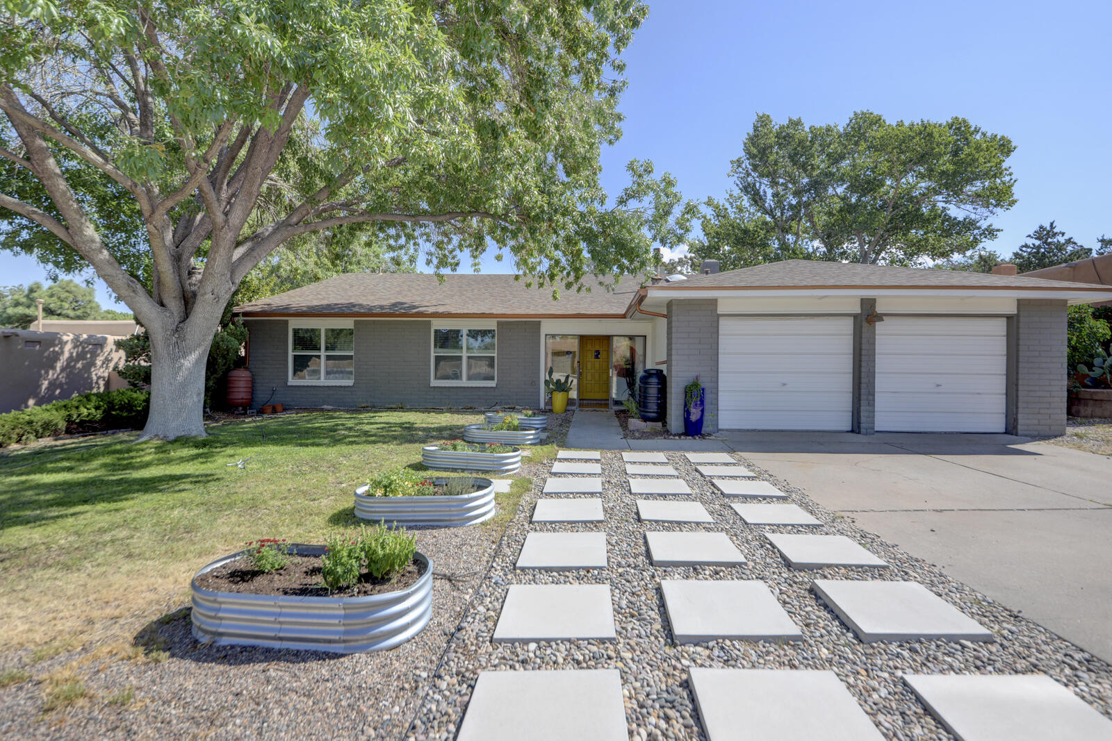 Loved & adored home brimming with good energy! Vibrant, colorful, lively abode in popular Academy Hills. Sunroom entrance opens to expansive great room with vaulted beam ceiling and a fireplace for warming chilly nights!  Patio doors lead to wonderful portal overlooking private shady backyard.  A tree house with slide will delight young and old alike!  Spacious primary opens to portal and features updated bath with oversized shower, vessel sink + walk in closet - WOW!  Ample kitchen is an artistic delight and casual eating area is great place to visit the cook! Both additional bedrooms are well proportioned and hall bath is updated! Roof new in 2020. A few blocks to Hubert Humphrey Elem. and LARGE  park!  Owners have LOVED their  neighbors and Welcome You to your new home!