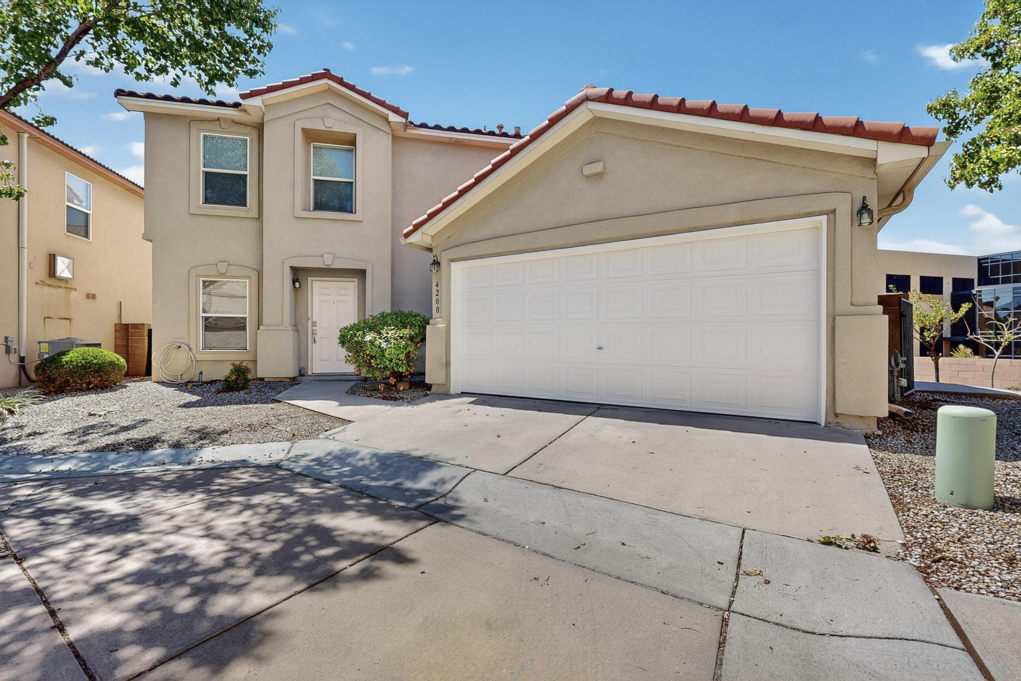 Discover comfort and security with this beautiful 4-Bedroom + Loft home, nestled in the private, gated Altura Village community. Just a short stroll from your front door, Enjoy a neighborhood playground and park inside secure gates. Inside, you'll find hardwood flooring throughout, an open floor plan bathed in natural light, and a spacious first-floor primary suite designed for ease and relaxation. Upstairs, three additional bedrooms and a versatile loft offer plenty of space for guests, a home office, or growing family needs. Enjoy the peace of mind that comes with a gated entrance and pedestrian-friendly streets, all while being minutes from UNM, Nob Hill, and convenient freeway access. This home blends thoughtful design with everyday convenience--perfect for connection, and community.