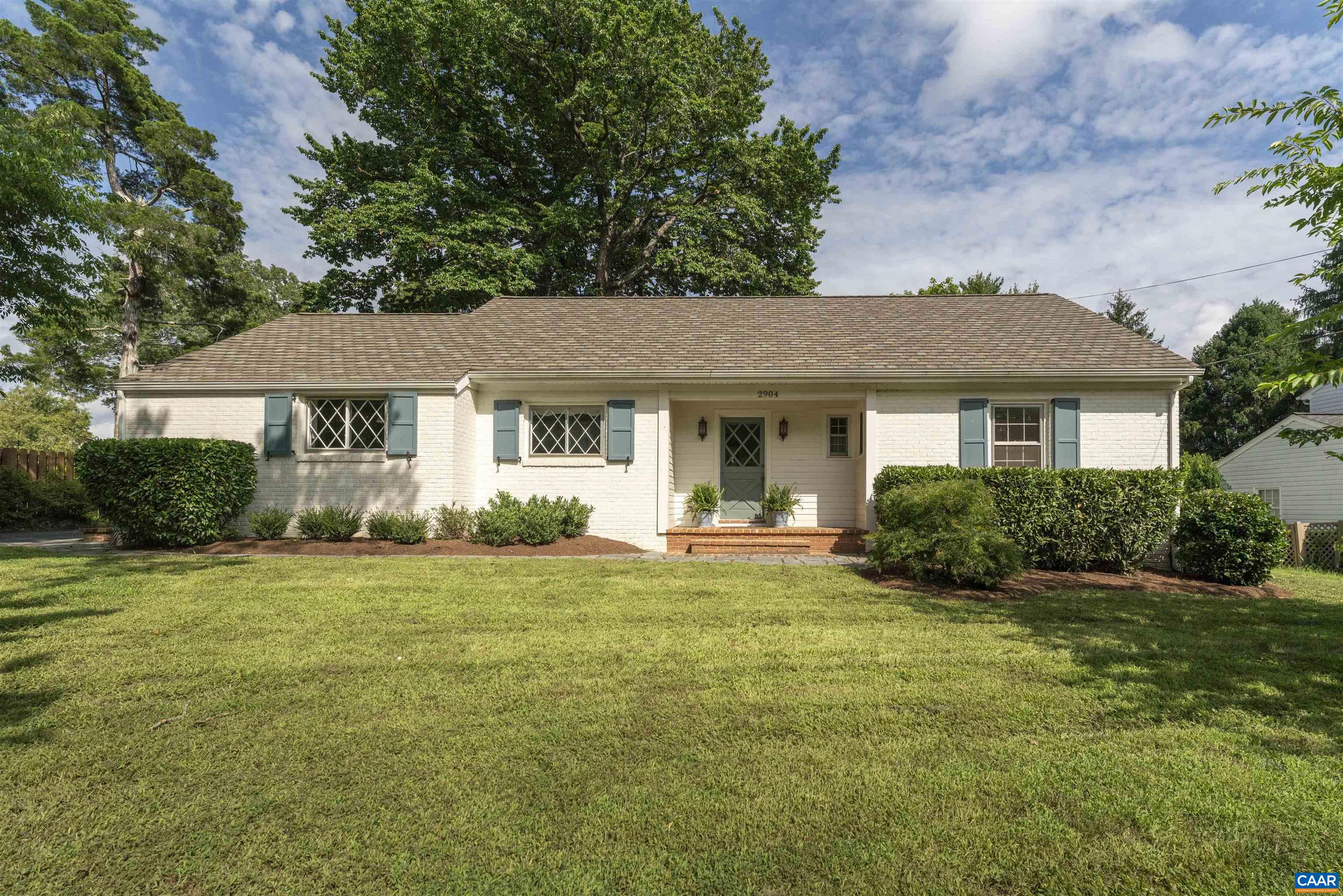 Welcome to one of Woodbrook’s most special homes - a picture-perfect brick ranch set on a lush, private 0.38-acre lot that feels like your own secret garden. Originally built as a model home in 1959, it’s been lovingly renovated with quality, comfort, and healthy living in mind. Inside, you’ll find three bedrooms, two stylish full baths, and a light-filled layout that flows beautifully for both everyday living and entertaining. The living room with wood-burning fireplace leads to a dining area and upgraded kitchen with granite counters, stainless appliances, and premium fixtures. An architect-designed sunroom with brick floors and Dutch door opens to a shaded deck and fenced backyard - an ideal setting for outdoor gatherings. Thoughtful details abound: diamond-mullioned windows, custom shutters and hardware, and light interiors painted with no/low-VOC paints. Architectural plans for a full second-story addition (two bedrooms, office, and bath) convey with the sale. A rare gem in a quiet, walkable neighborhood - just minutes from parks, schools, and everything Charlottesville has to offer.