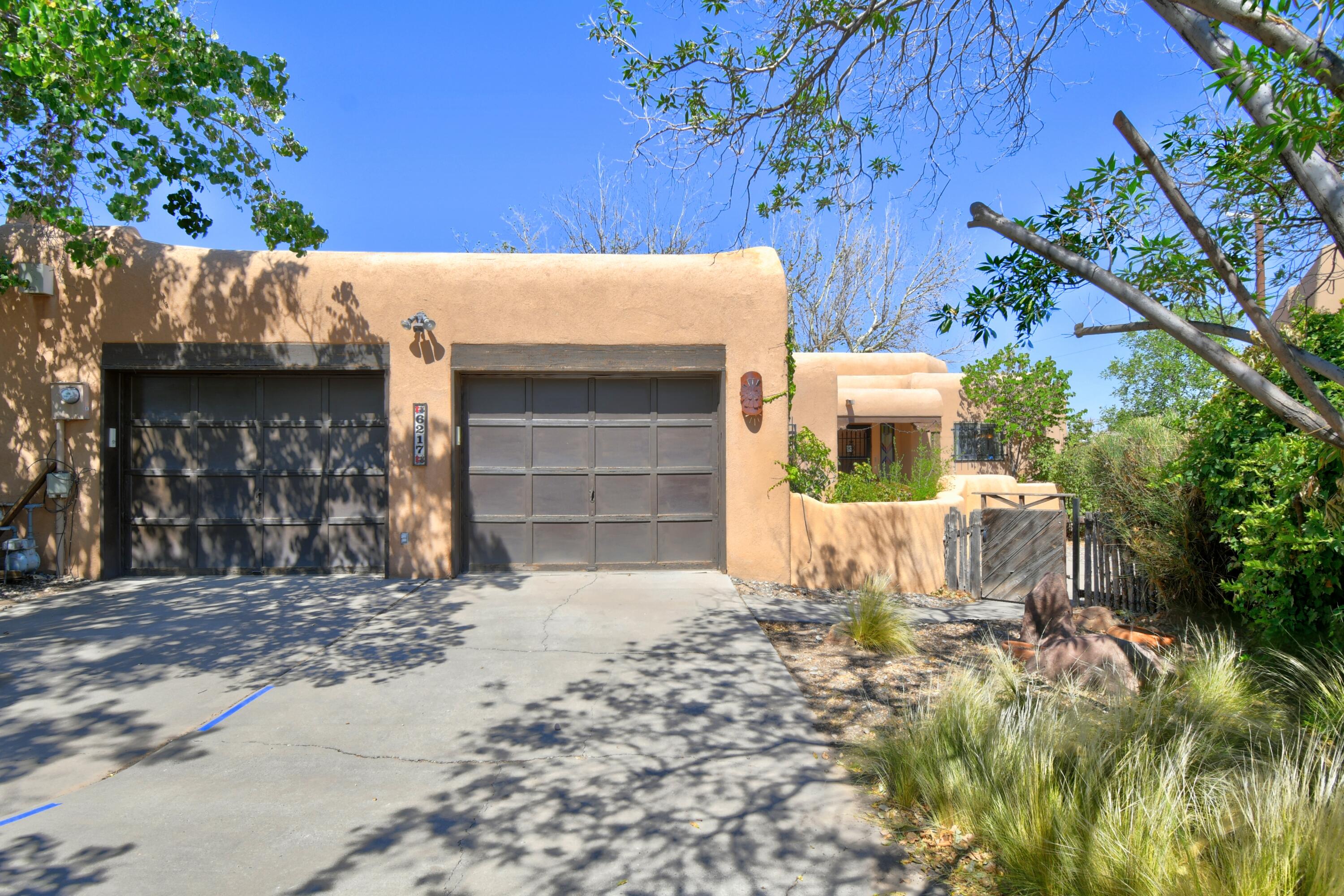 Welcome to this Charming home in Albuquerque's North Valley. Situated in a quaint & quiet cul de sac. A WELCOMING courtyard greets you. Boasting BEAUTFULL SW accents. BEAUTIFULL Beamed Ceilings w/ Tongue & Groove Accents. Custom built in book cases. OPEN, BRIGHT Living, Dinning & Kitchen. LOTS of counter space & cabinet space in Kitchen w/ a cozy island to sit and just be. Generous Master Bedroom w/ side door that leads to a beautiful private courtyard/backyard. Separate shower & tub AND A BIDET for your comfort! Skylights offering even more light!  Generous secondary bedrooms too! OVERSIZED two door garages w/ additional storage. Providing ample space for tools, hobbies, or extra storage and a workshop/workbench. Plenty of room in backyard too, open up & entertain. Side yard access possi