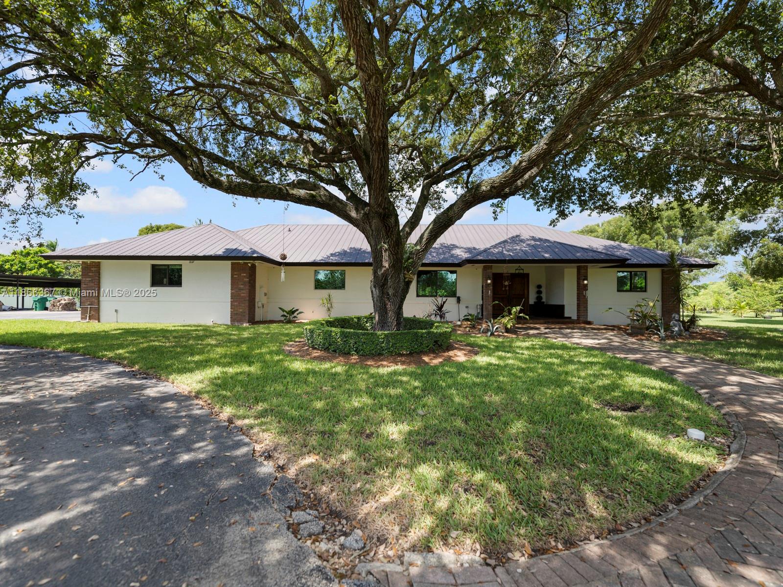 Tranquil farmhouse retreat on 2.23 acres in The Redlands. Surrounded by beautiful oak trees and secured with a concrete fence and gated entry, this property offers the perfect blend of privacy and charm. The spacious open floor plan is ideal for entertaining, featuring 4 bedrooms, 3.5 baths, and a legal addition with a family room. A separate in-law studio with bath provides flexibility for guests or extended family. Enjoy a 2-car garage, carport, and plenty of space for toys or farm equipment. The grounds are filled with seasonal fruit trees, and a large sparkling pool creates the perfect outdoor oasis. Escape the city and embrace the peace and beauty of The Redlands in this one-of-a-kind retreat.