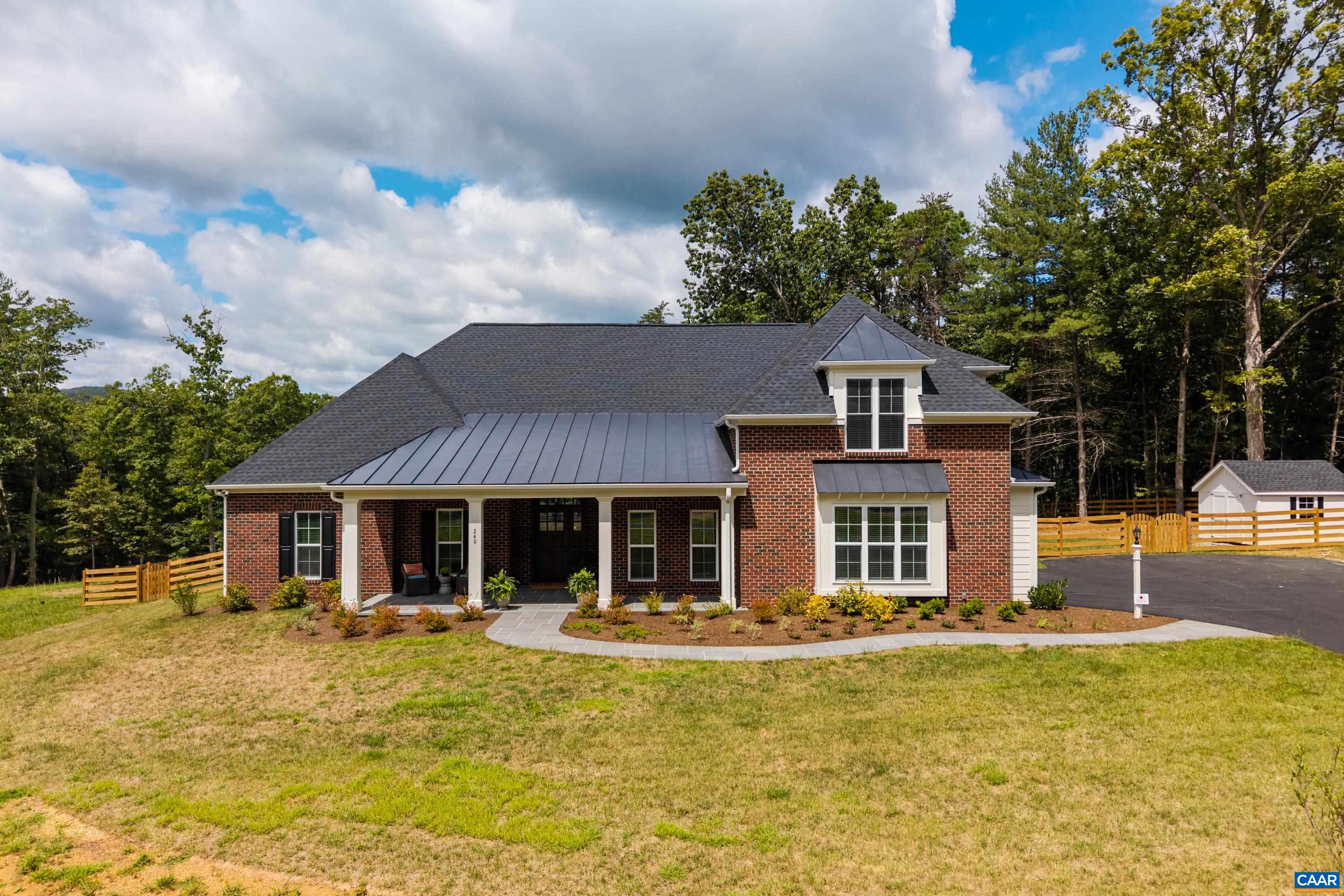 Set on a tranquil five-acre parcel just minutes from Keswick Hall and less than 15 minutes to downtown Charlottesville, this like-new home combines refined design with thoughtful upgrades. The modified floor plan enhances everyday living with a light-filled open concept that still preserves a traditional dining room and private office/den. The great room, with vaulted ceiling and seamless patio access, adjoins a gourmet kitchen outfitted with GE Monogram appliances, quartz countertops, and both a walk-in and butler’s pantry. The primary suite, privately tucked away, features a spa-like bath and enlarged walk-in closet. Two main-level guest bedrooms and a well-planned laundry complete the first floor, while an upstairs loft with full bath and bonus room offers flexibility for a fourth bedroom or retreat. Surrounded by farms and conservation land, the property enjoys a peaceful setting with seasonal mountain views and sunsets from the expansive bluestone patio. Level and mostly cleared, the land offers endless potential for gardens, outbuildings, or a pool. Elegant, practical and well-appointed, this property embodies the best of Virginia country living with all the convenience of a brand-new home.