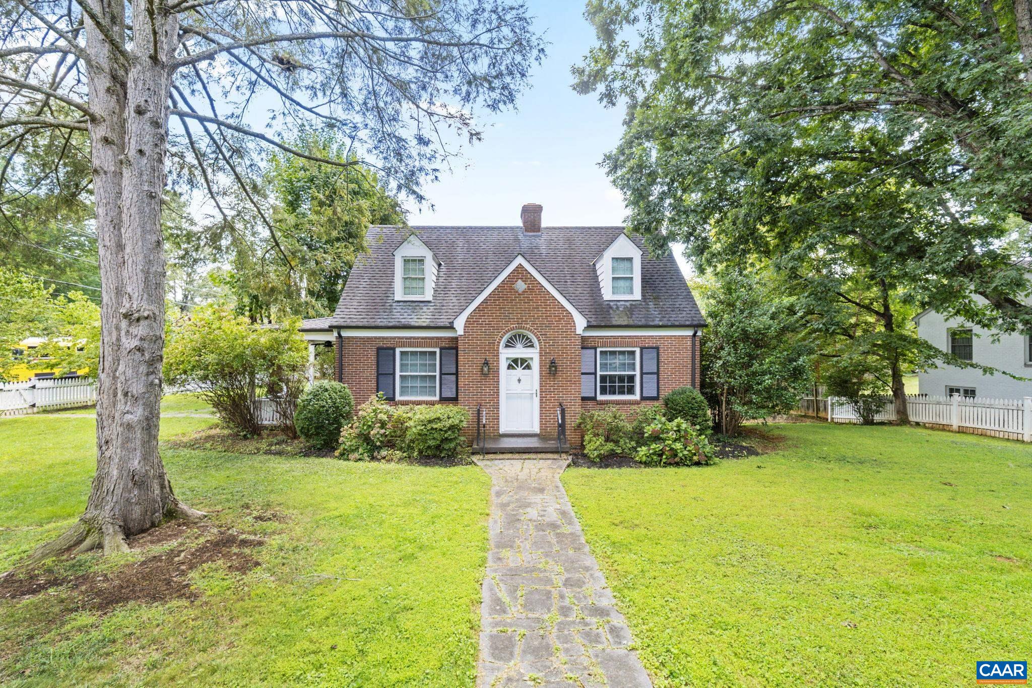 This delightful 3-bedroom, 2.5-bath cottage in the heart of Charlottesville blends storybook charm with urban convenience. The large city lot boasts a level yard with various useable spaces, two covered porches, fire pit, large shed, and a picket fence enclosure. The ideal location is walkable to the University, McIntire Park, Main Street, the Downtown Mall and The Dairy Market, as well as the Rivanna trail system and the YMCA. The well-maintained interior features hardwood floors throughout and updated kitchen and bathrooms. A finished basement offers ample space for storage, a guest area, and a laundry room.   Enjoy hosting in the spacious dining and living rooms, or relax outdoors under mature hardwoods and fruit trees that grace the well-landscaped yard. Set on a generous corner lot, the property is newly rezoned as Residential-Commercial and offers incredible potential for future additions such as an ADU or dwelling space.  Recent additions adding great value and peace of mind include new HVAC system and water/sewer lines connecting to Public Utilities.   This home is a true gem where charm, functionality, and opportunity meet.