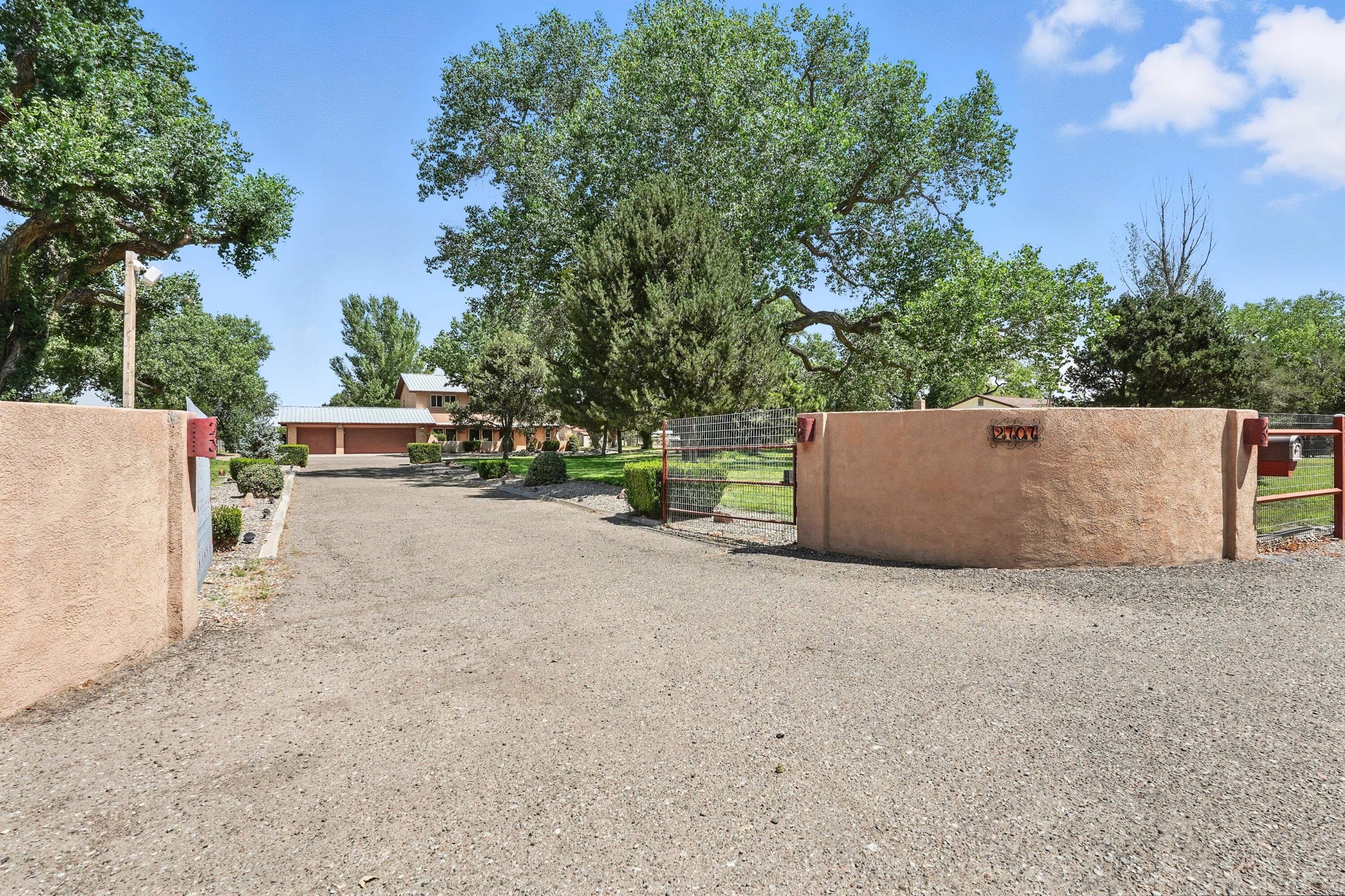Discover the charm of South Valley living at 2707 Garner Rd SW. Set on 1.25 acres of lush, park-like grounds, this rare property offers over 2,800 sq ft of living space with 3-4 bedrooms and 3 baths. Towering trees and sprawling green lawns create a peaceful retreat, while the spacious layout provides room for family, entertaining, or a home office. Nestled in one of the area's desirable neighborhoods, this home offers the perfect balance of tranquility and convenience. Solidly built and full of potential, it's ready for your personal upgrades to make it truly your own. Whether you dream of gardens, gatherings, or simply space to breathe, this South Valley gem is ready to welcome you home.