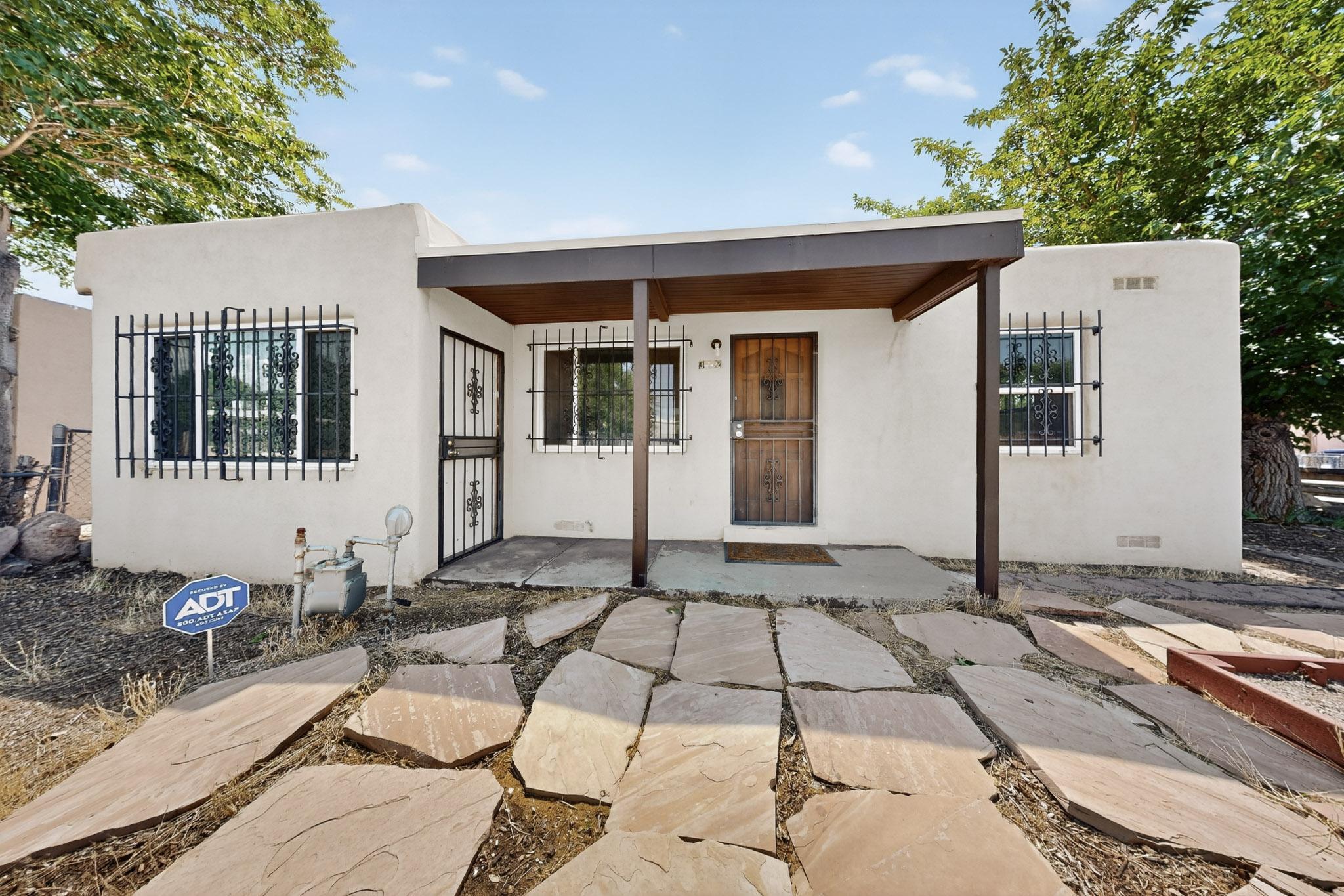 Welcome to this $220K starter home in the tree-lined Pat Hurley neighborhood! Offering 2 bedrooms plus an office that could be a 3rd bedroom, this home combines charm and function. Inside you'll find refinished hardwood floors in the living room, primary bedroom, and walk-in closet, along with a brand-new gas stove and new washing machine. A new TPO roof adds long-term peace of mind. Just minutes from Historic Route 66, Old Town, the BioPark, UNM, CNM, and Downtown, you'll love the convenience of being close to shopping, dining, and entertainment. Perfect for first-time buyers, this property also qualifies for programs offering no money down. Affordable, updated, and ideally located--this home is ready for its next chapter.
