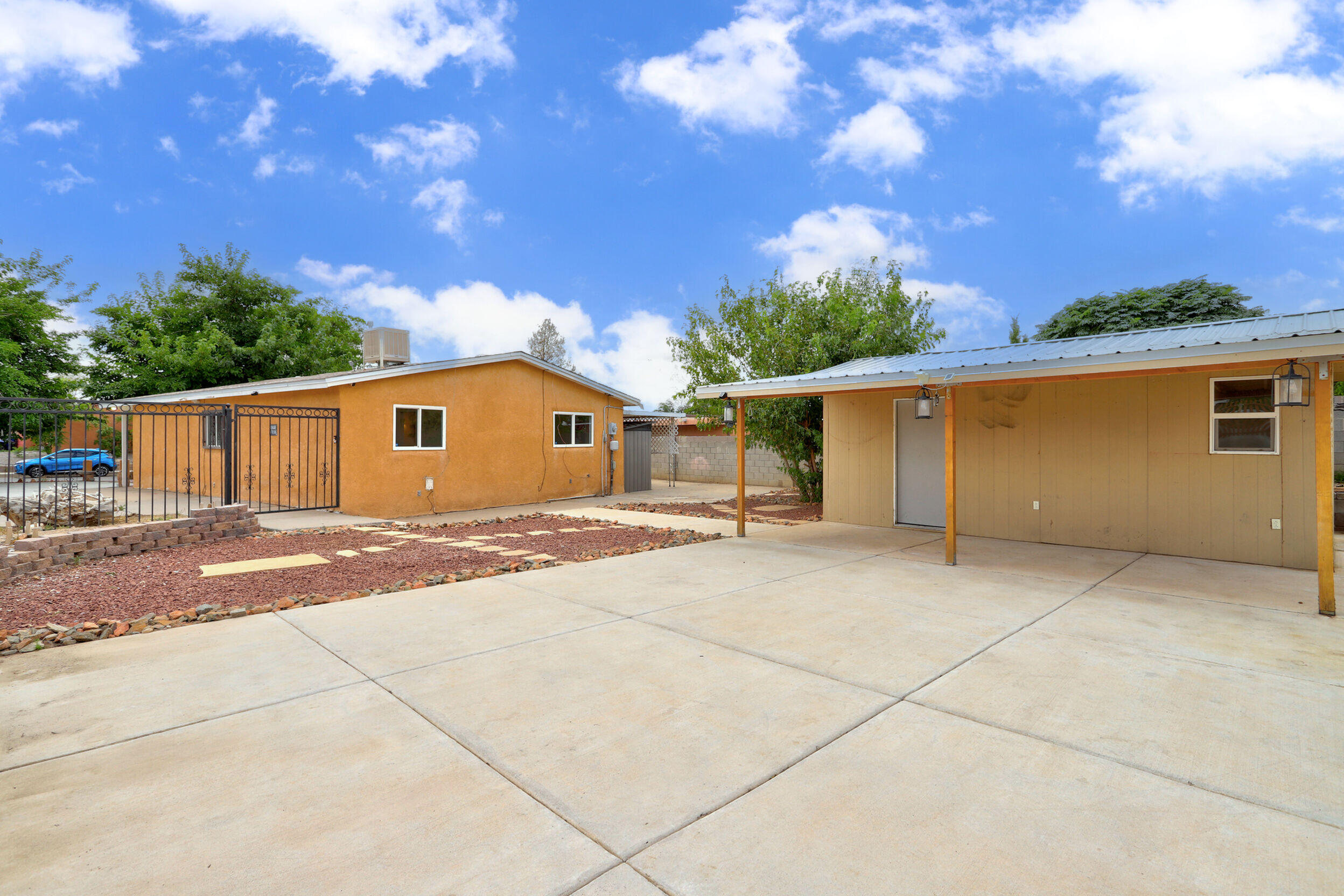 Exceptional. Come discover this rare market find in an ideal location 1 block from the park and with easy interstate access to get anywhere you want to be in the city quickly! What makes it such a rarity is the extended parking available on the corner lot and DREAM 225 square foot workshop with power recently added to the spacious and private yard. Other special features include energy-saving vinyl thermal windows, efficient new cooler, split system in primary for nice n' cold sleeping, fresh neutral interior paint, new carpet or laminate flooring throughout, updated kitchen with white cabinetry | stainless steel appliances | granite countertops | undermount sink, huge primary bedroom with walk in closet, and tons of outdoor living spaces under 2 big covered patios. A MUST SEE!
