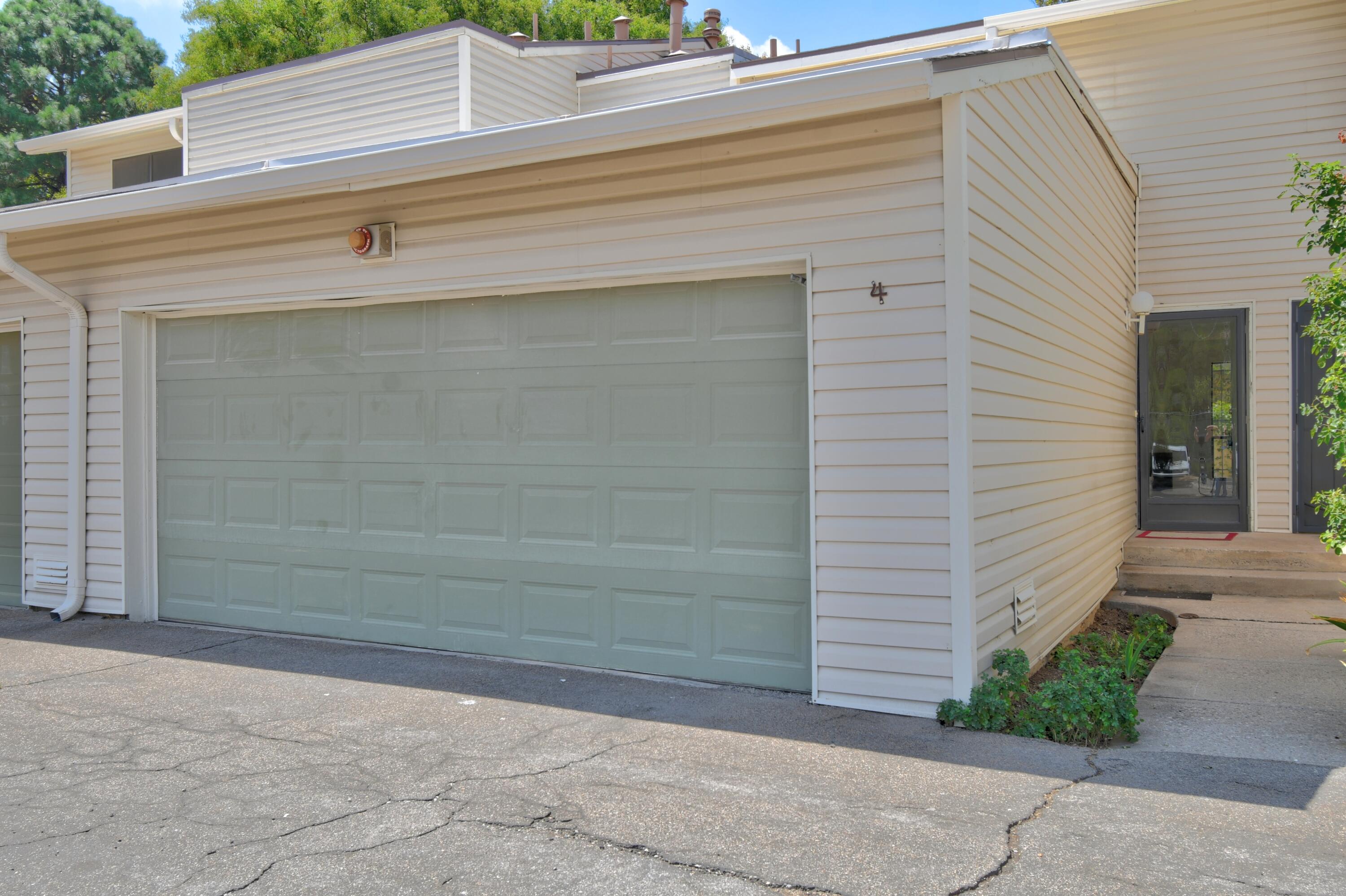 Welcome to The Shores--a charming townhouse community in the Northeast Heights, conveniently located near shopping, dining, and all the amenities needed for a comfortable lifestyle. This home is perfect for a handyman or investor, offering plenty of opportunity and potential. Recent updates include fresh paint and new carpet.The property features two bedrooms, three bathrooms, a two-car garage, and a fully finished basement with a three-quarter bath. The living room includes a cozy wood-burning fireplace and opens to the kitchen, creating a warm and inviting space.The HOA covers water, sewer, trash, exterior maintenance, roof, siding, common areas, clubhouse, community pool, and tennis courts. Enjoy the park-like setting with plenty of walking areas, along with the pool and clubhouse for